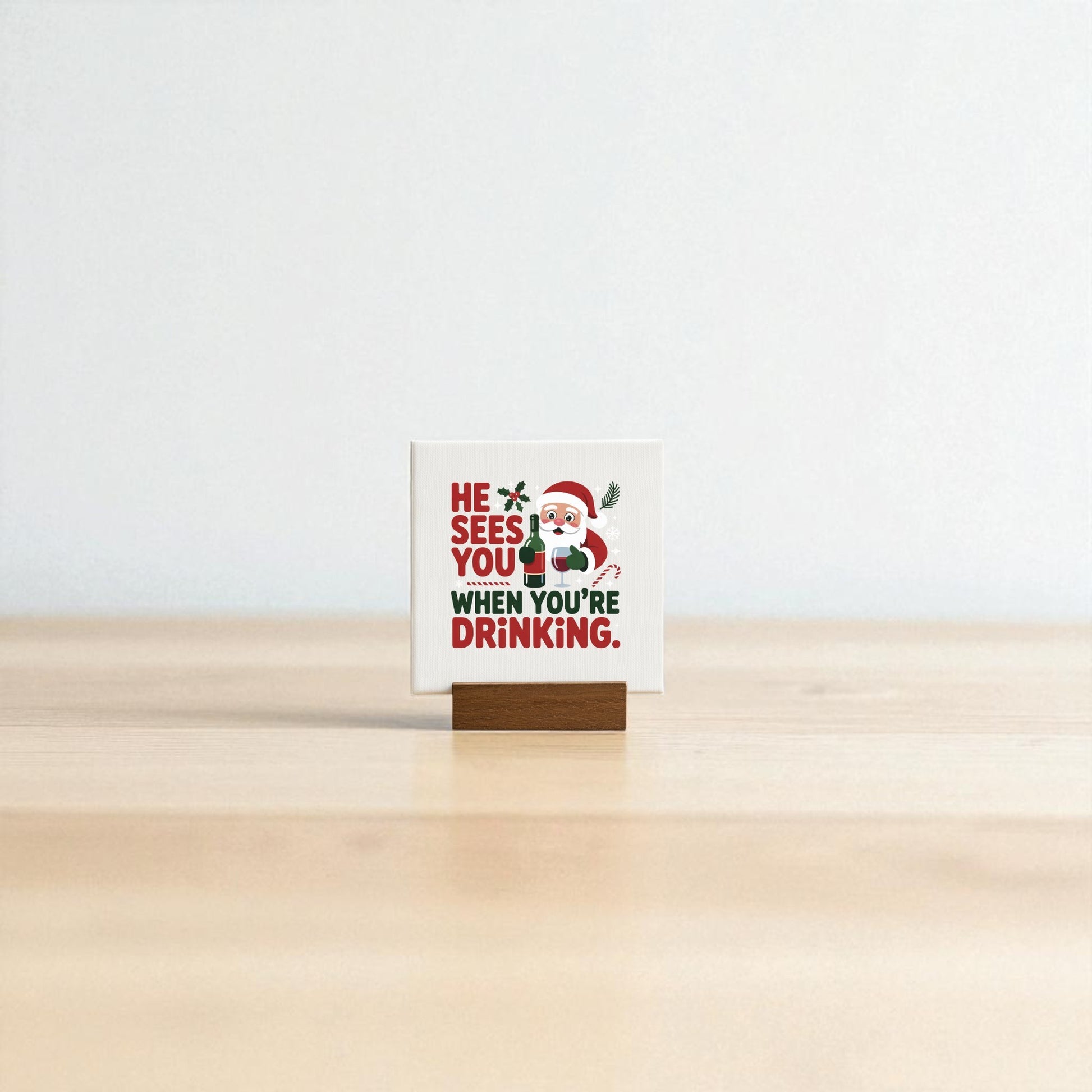 The "He Sees You When You’re Drinking" Funny Mini Christmas Sign by Mirabilia Boutique features Santa and witty text on a wooden holder—a playful holiday décor piece for your bar cart or a fun gift for wine lovers.