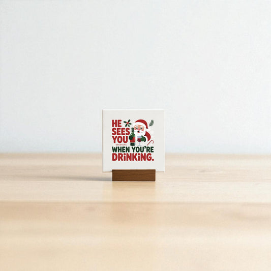 The "He Sees You When You’re Drinking" Funny Mini Christmas Sign by Mirabilia Boutique features Santa and witty text on a wooden holder—a playful holiday décor piece for your bar cart or a fun gift for wine lovers.