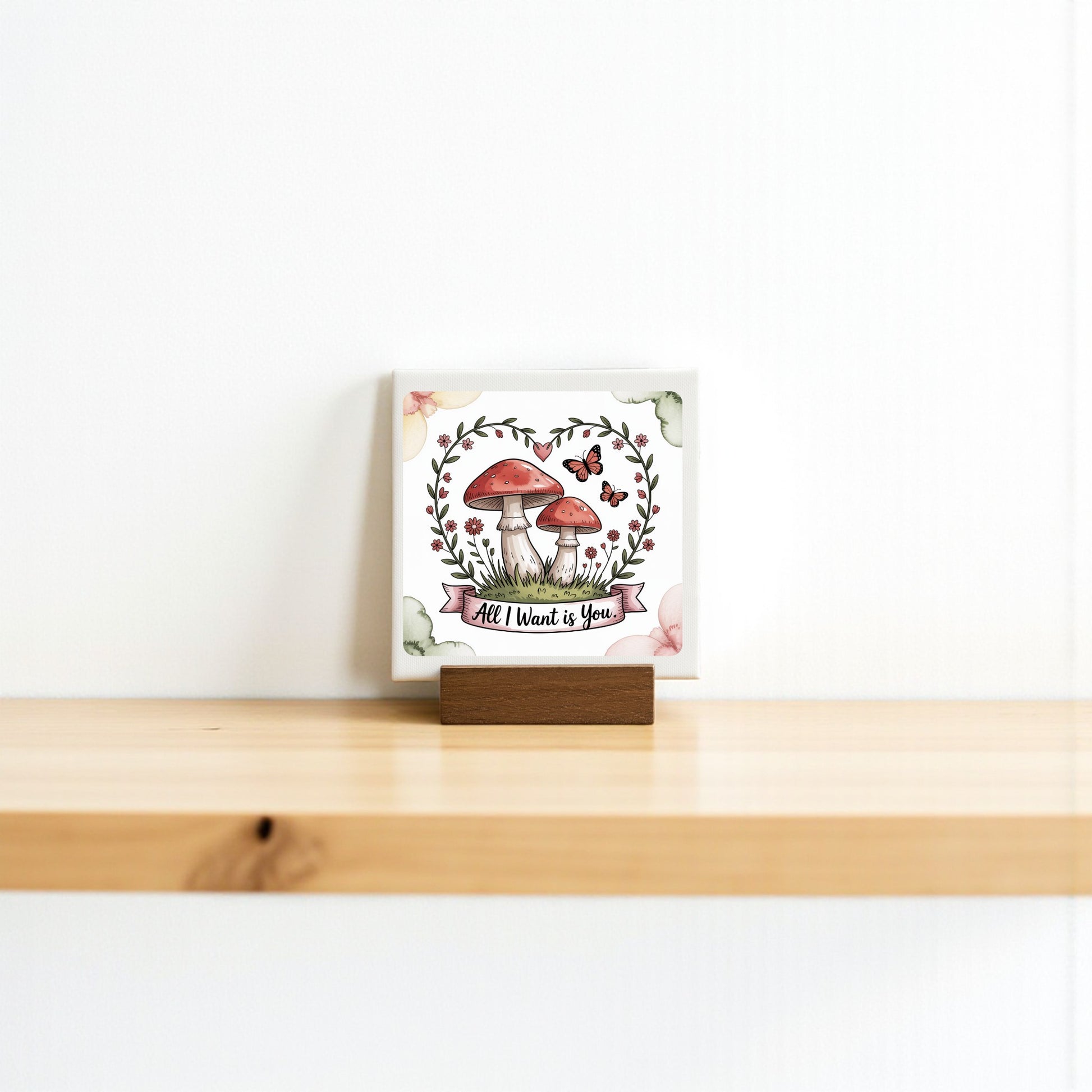 The Mini Mushroom Love Sign by Mirabilia Boutique features red mushrooms, leaves, and butterflies with "All I Want Is You" text—ideal 4x4 cottagecore decor or a romantic gift.