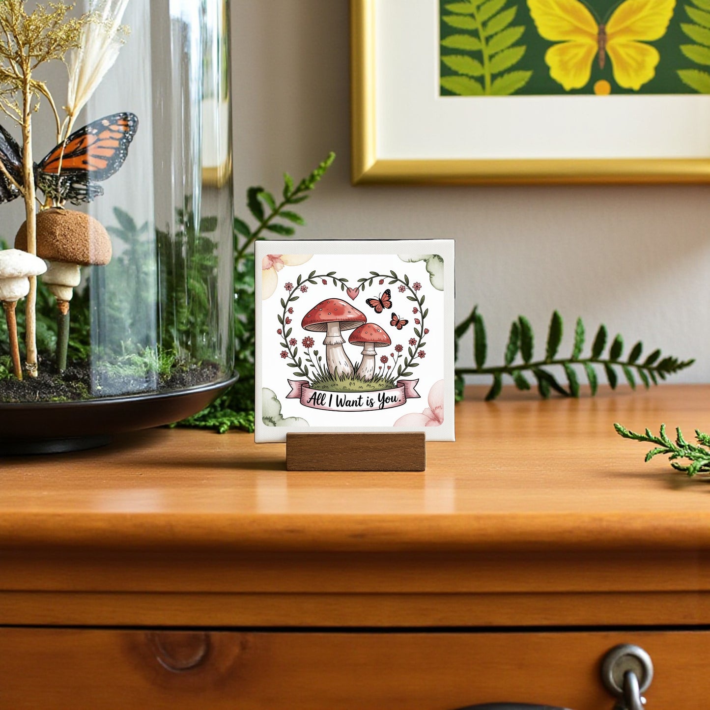 The Mini Mushroom Love Sign | All I Want Is You | 4x4 by Mirabilia Boutique features red mushrooms, butterflies, and leaves—a charming cottagecore accent or romantic gift, perfect for adding whimsy to any dresser or shelf.