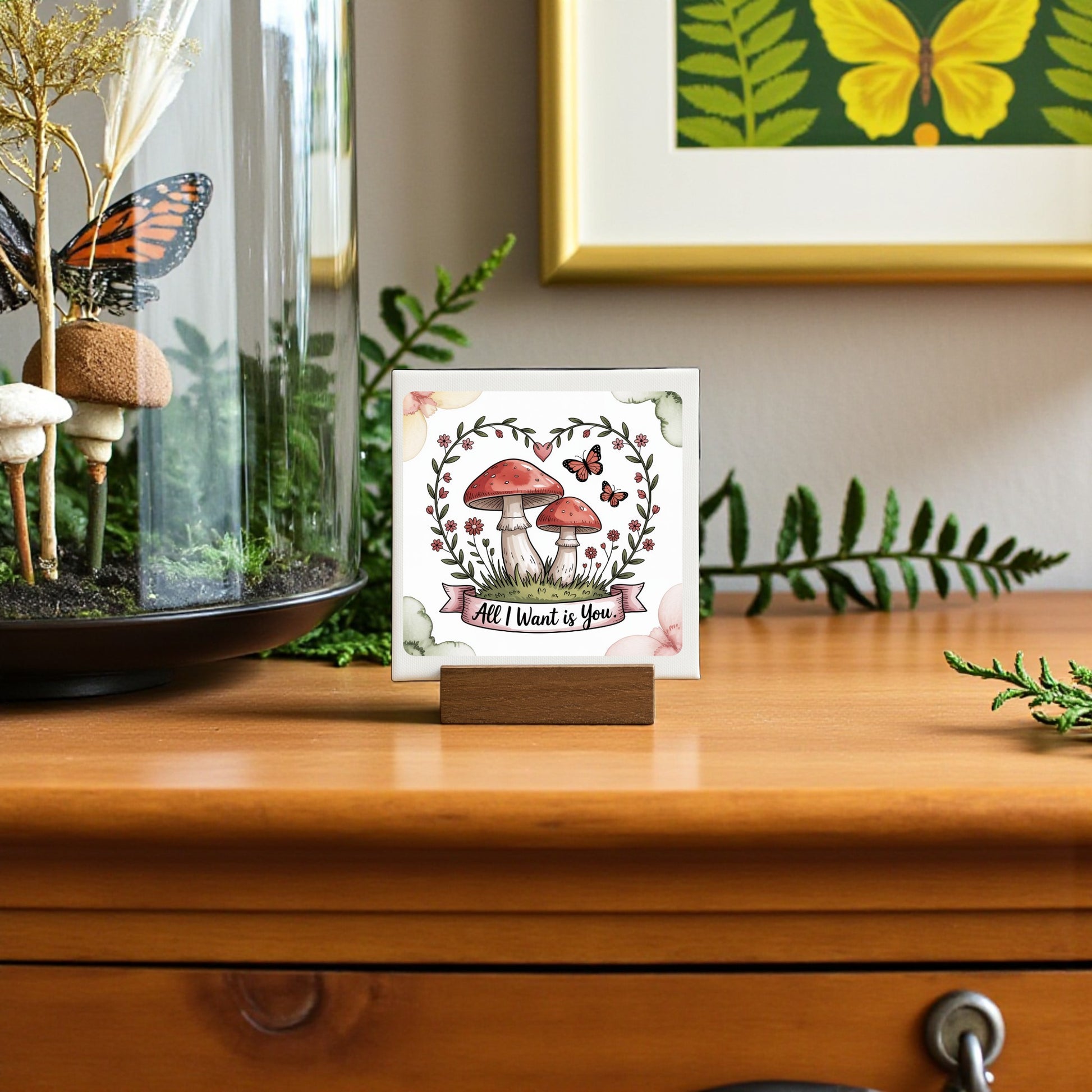 The Mini Mushroom Love Sign | All I Want Is You | 4x4 by Mirabilia Boutique features red mushrooms, butterflies, and leaves—a charming cottagecore accent or romantic gift, perfect for adding whimsy to any dresser or shelf.