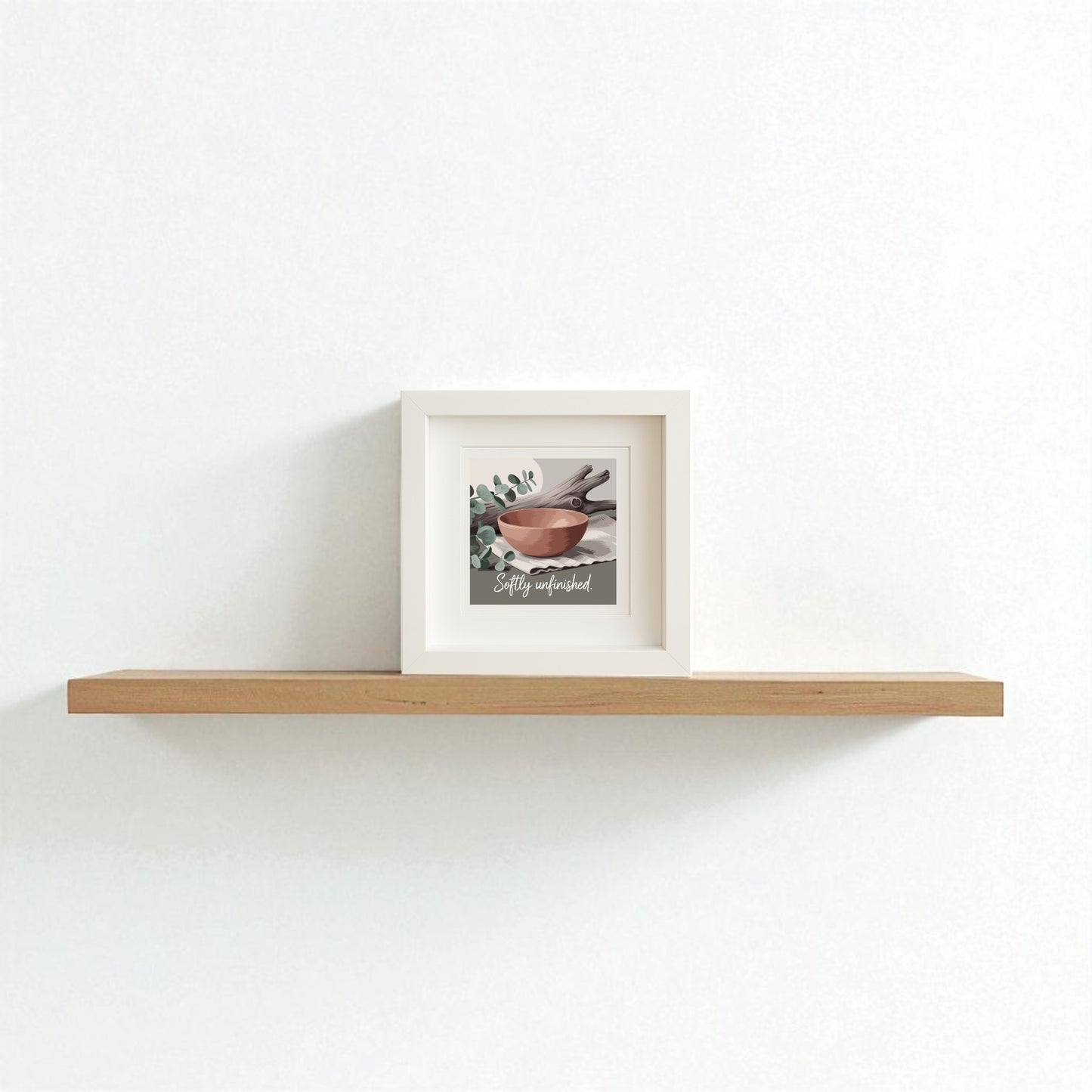 The Mirabilia Boutique Softly Unfinished Shadowbox | Wabi Sabi Boho Wall Art features a painting of bowls and leaves with the phrase "Stay wonderful," adding modern boho charm to your space on a light wooden floating shelf.