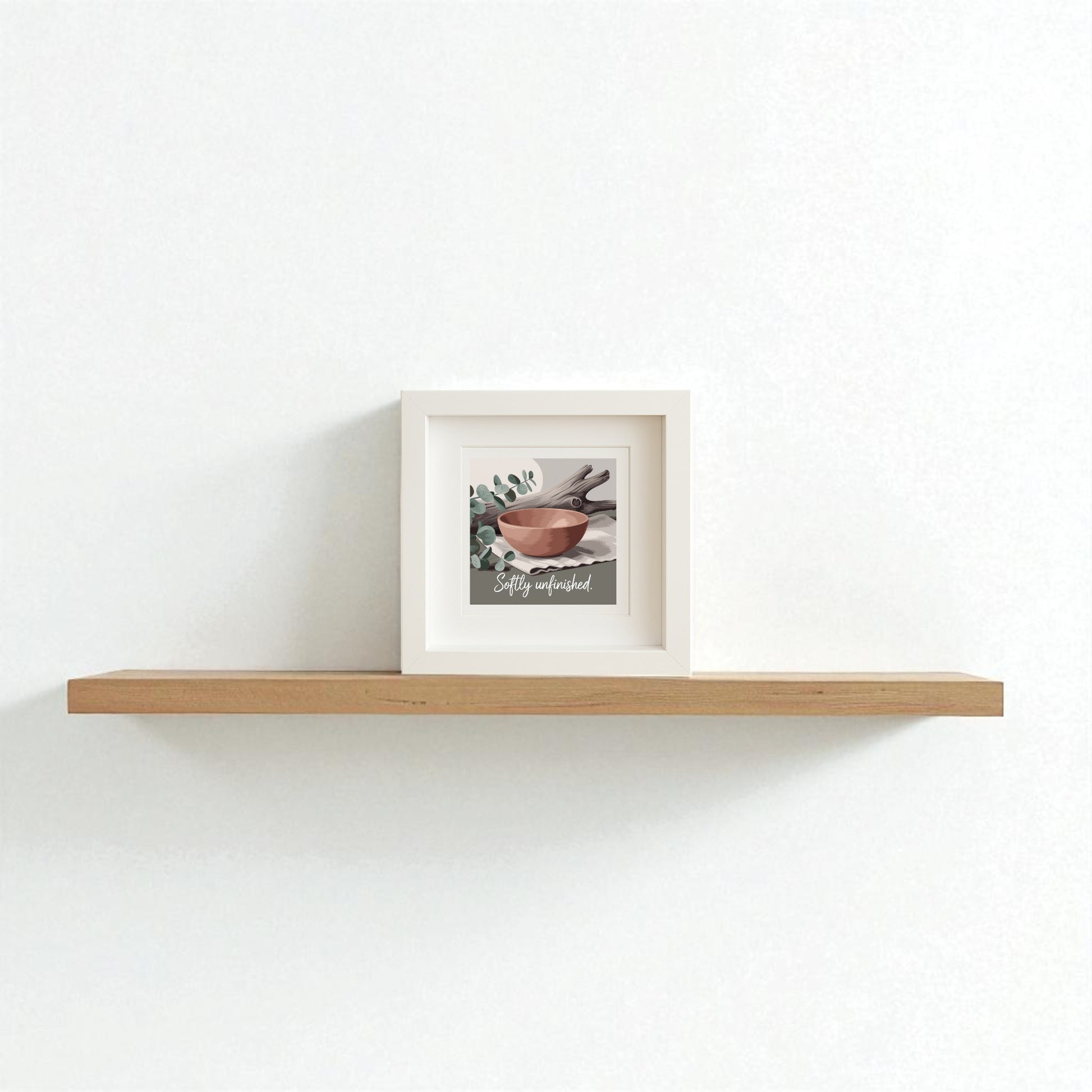 The Mirabilia Boutique Softly Unfinished Shadowbox | Wabi Sabi Boho Wall Art features a painting of bowls and leaves with the phrase "Stay wonderful," adding modern boho charm to your space on a light wooden floating shelf.