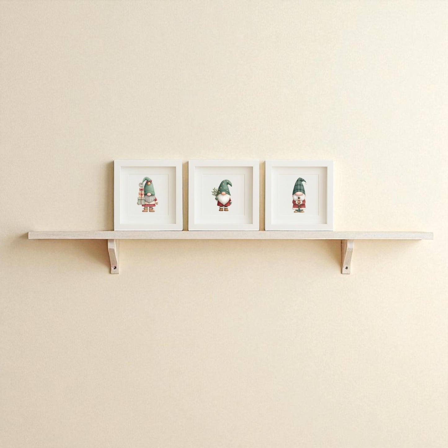 The Mirabilia Boutique Scandinavian Gnome Art Trio features three crisp white-framed prints, adding Nordic flair and festive charm to a plain beige wall—ideal framed Christmas decor for a cozy holiday touch.