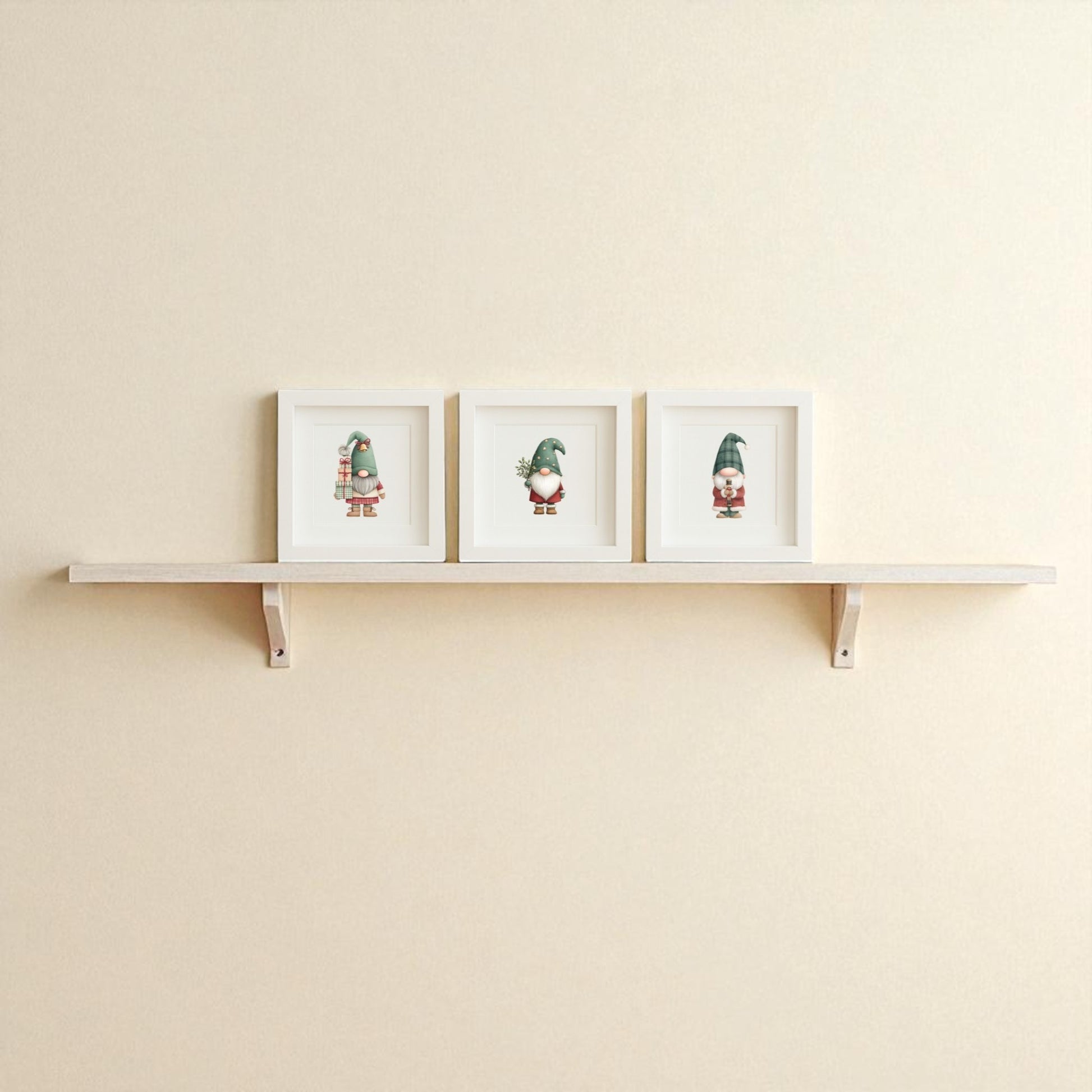 The Mirabilia Boutique Scandinavian Gnome Art Trio features three crisp white-framed prints, adding Nordic flair and festive charm to a plain beige wall—ideal framed Christmas decor for a cozy holiday touch.