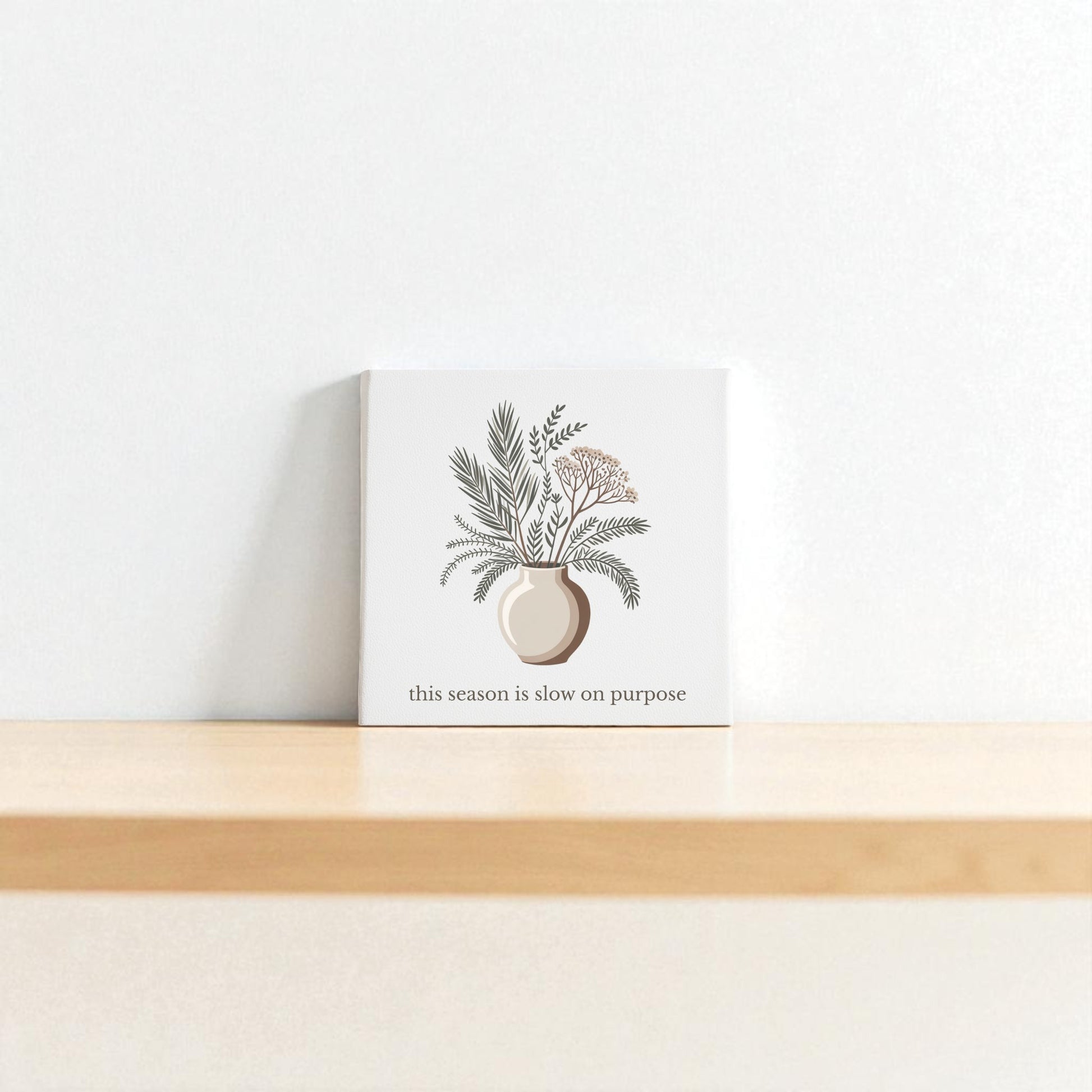 The “Slow on Purpose Canvas” by Mirabilia Boutique features a minimalist botanical vase design and inspiring quote, printed on plain white canvas—perfect wall art for those who value intentional living.