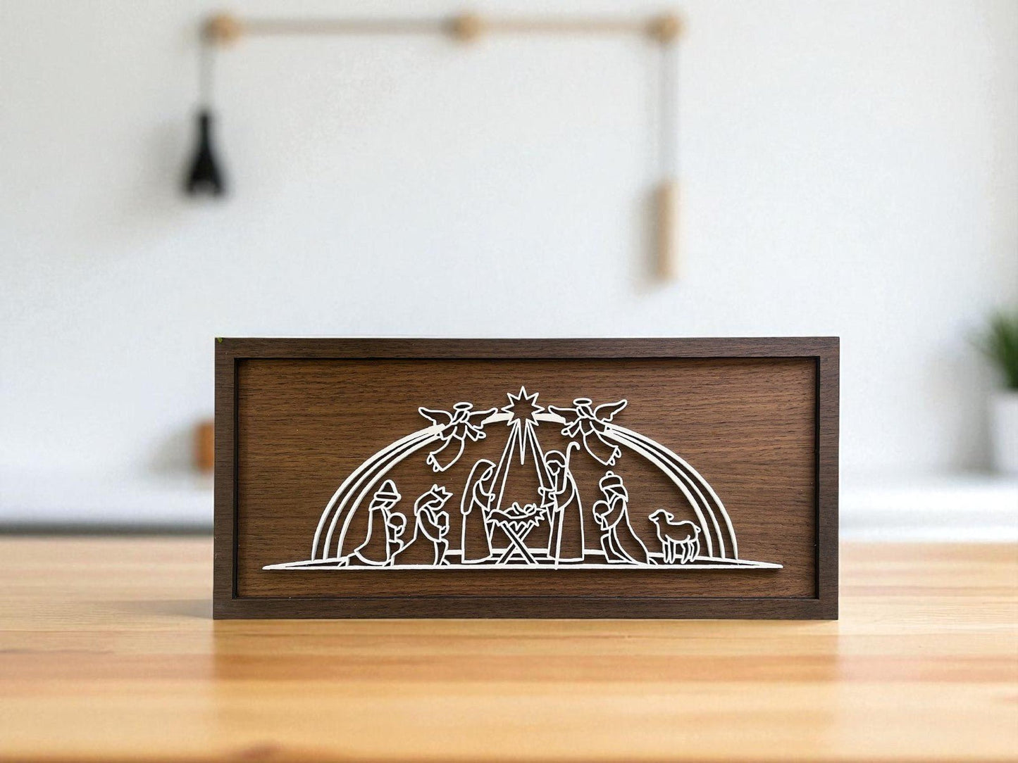 The Laser Cut Nativity Sign by Mirabilia Boutique is a handmade 9x4 wooden plaque featuring a minimalist white line Holy Family scene—Mary, Joseph, baby Jesus, animals, angels, and star—perfect Christmas decor for your home.