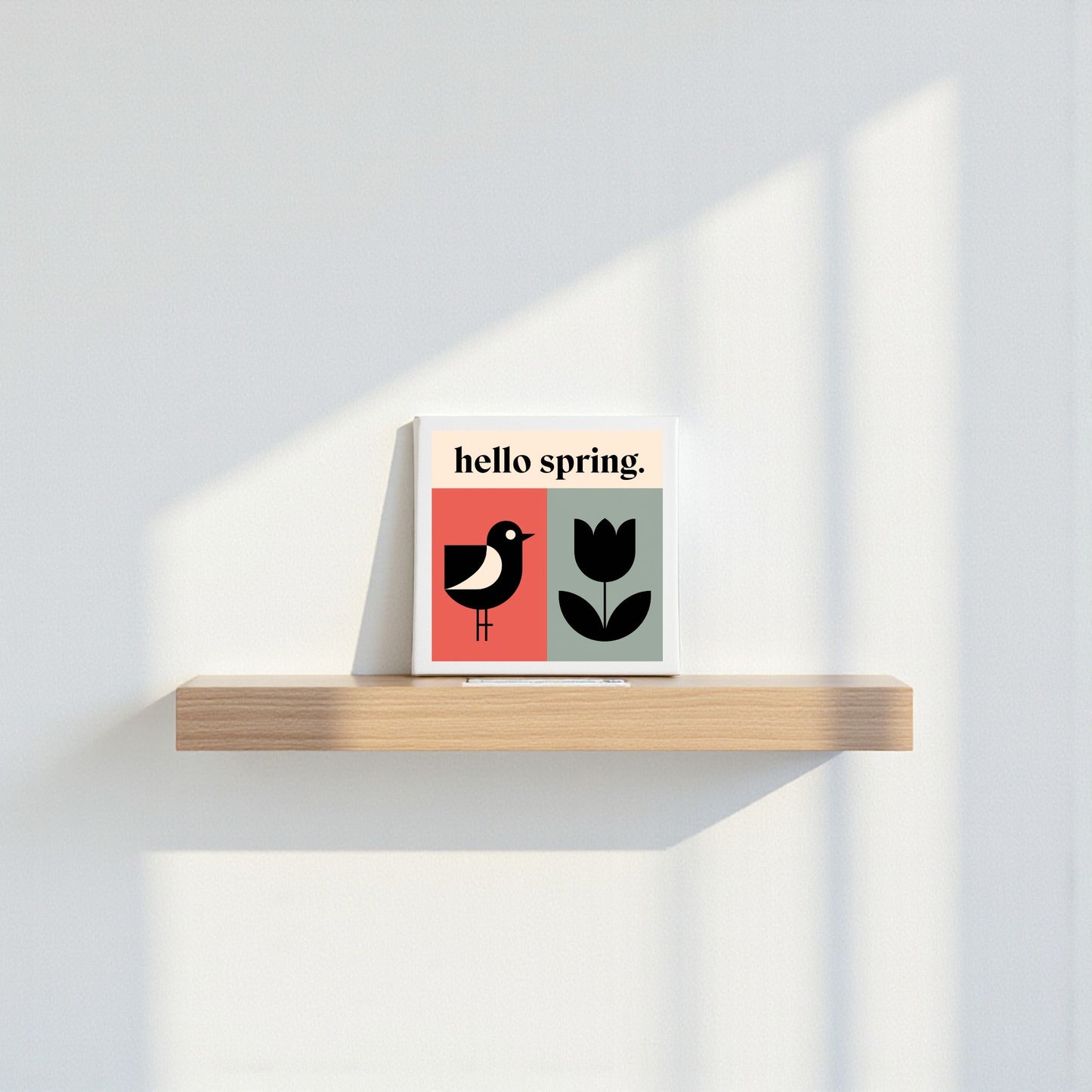 The Hello Spring Canvas – Bird & Tulip Wall Art by Mirabilia Boutique features minimalist spring decor with a bird, tulip, and "hello spring" text on canvas—perfect for brightening your home with modern, cheerful style.