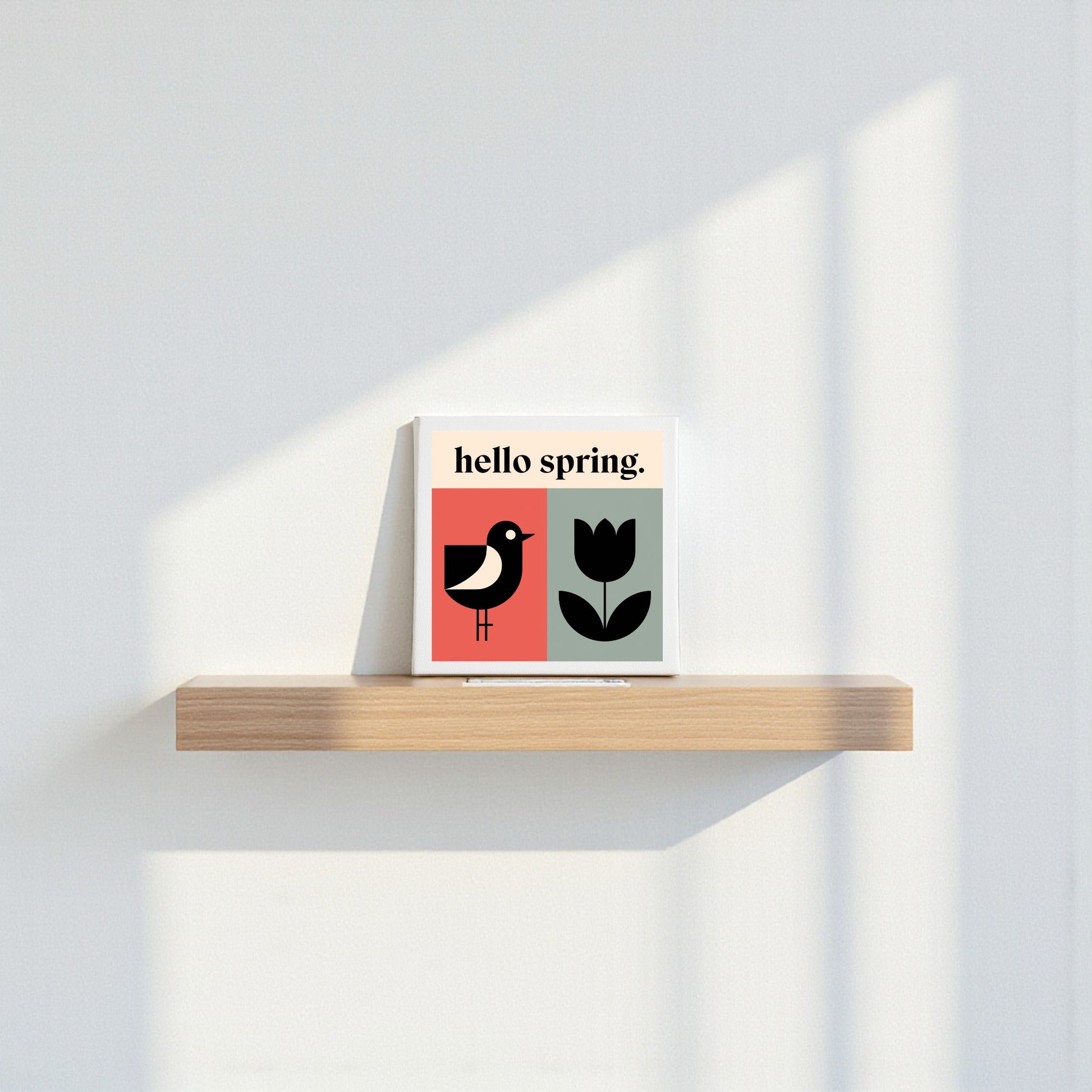 The Hello Spring Canvas – Bird & Tulip Wall Art by Mirabilia Boutique features minimalist spring decor with a bird, tulip, and "hello spring" text on canvas—perfect for brightening your home with modern, cheerful style.