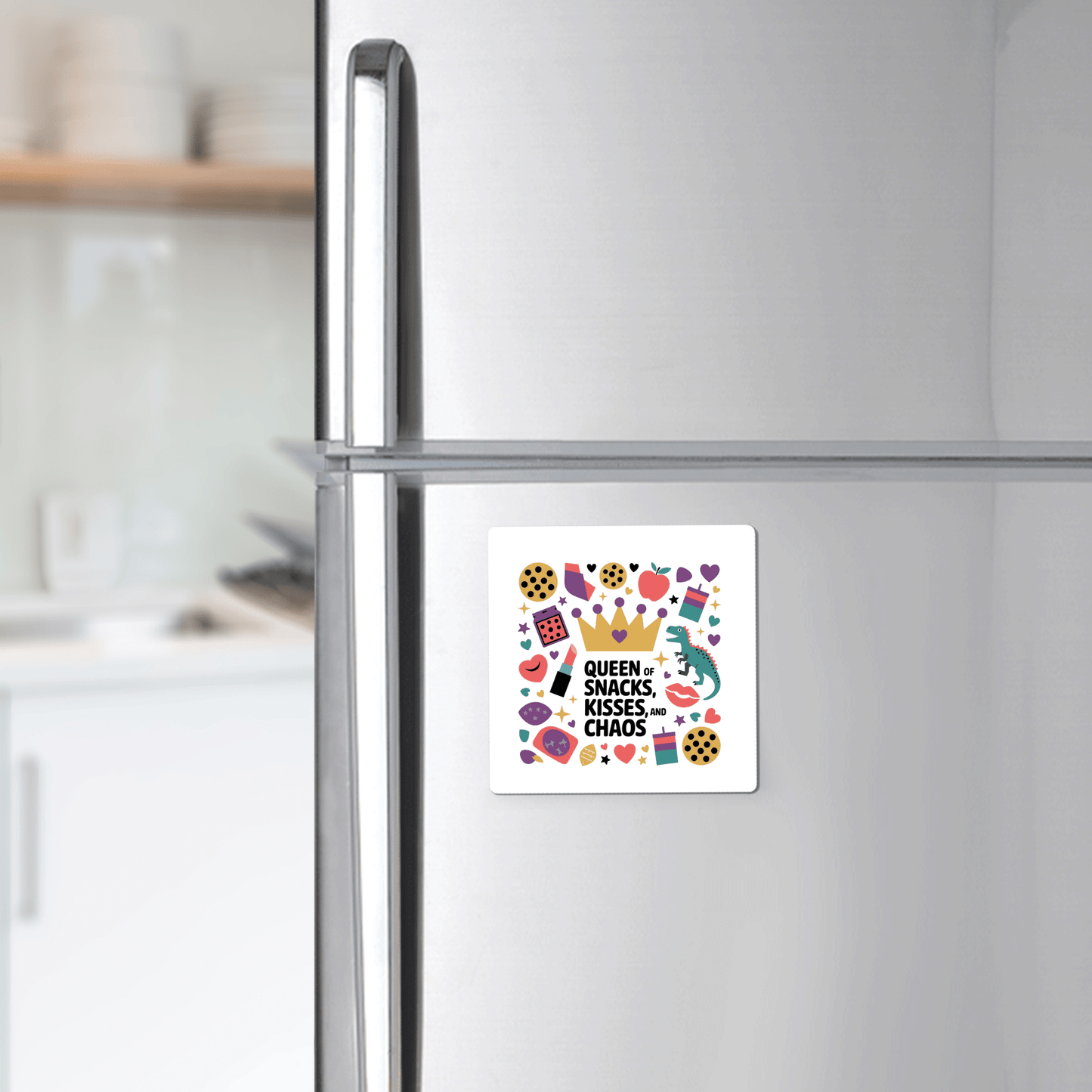A Mirabilia Boutique Queen of Snacks Magnet – a funny, colorful mom life gift – decorates a stainless steel fridge with “Queen of Snacks, Kisses & Chaos” and playful art, perfect for adding cheer to any kitchen.