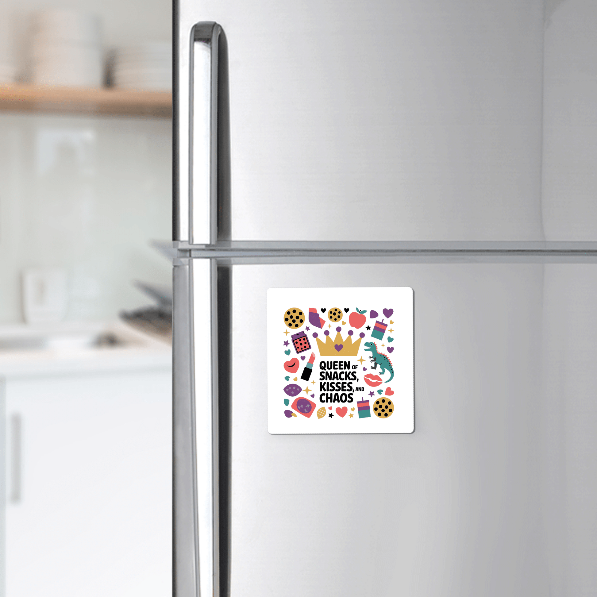 A Mirabilia Boutique Queen of Snacks Magnet – a funny, colorful mom life gift – decorates a stainless steel fridge with “Queen of Snacks, Kisses & Chaos” and playful art, perfect for adding cheer to any kitchen.