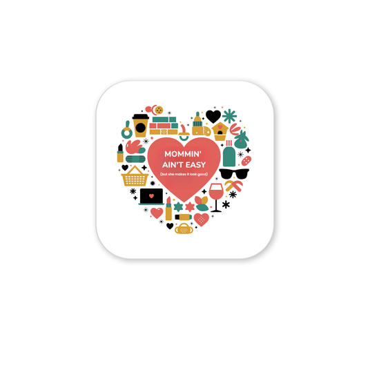 The “Mommin’ Ain’t Easy Magnet” by Mirabilia Boutique features a heart of colorful icons and “Mommin’ Ain’t Easy (but she makes it look good)” at the center—a cheerful Mother’s Day gift or fun Mom magnet!.