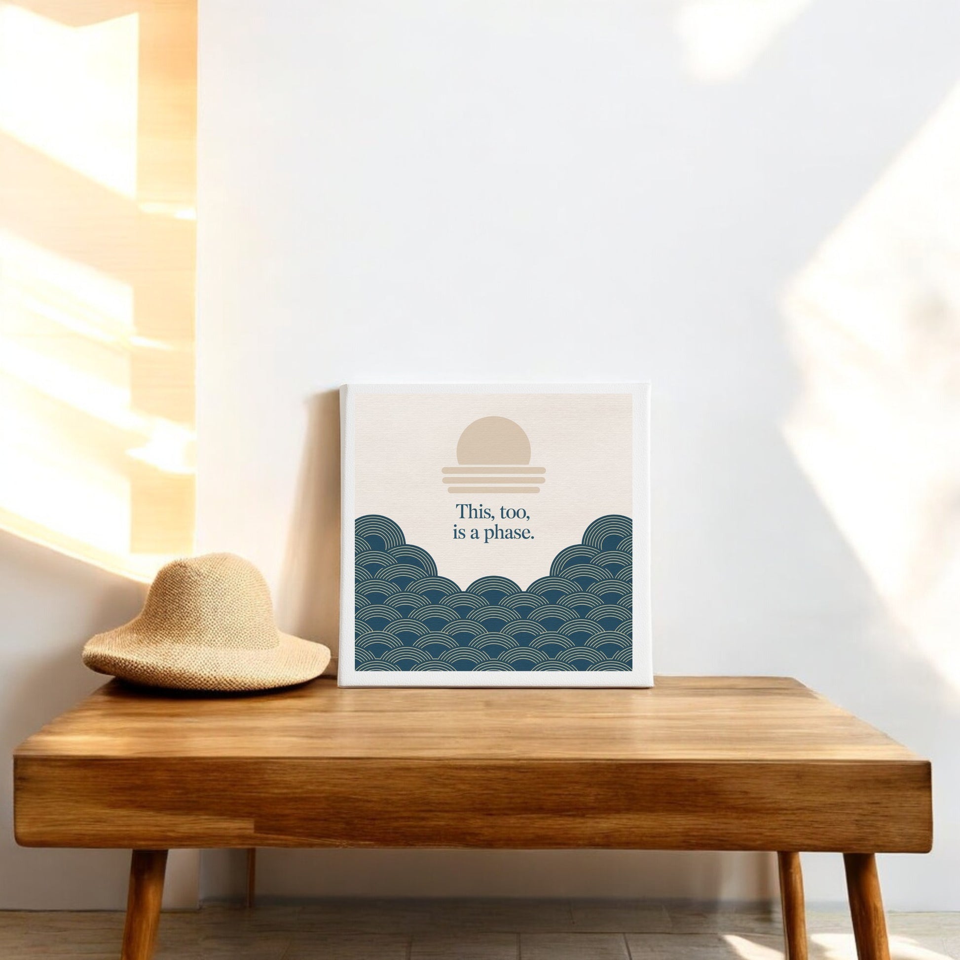 The "This Too Is a Phase Canvas – Calming Summer Wall Art" by Mirabilia Boutique features an abstract sun and waves design with the phrase "This, too, is a phase," bringing serene summer vibes to your space.