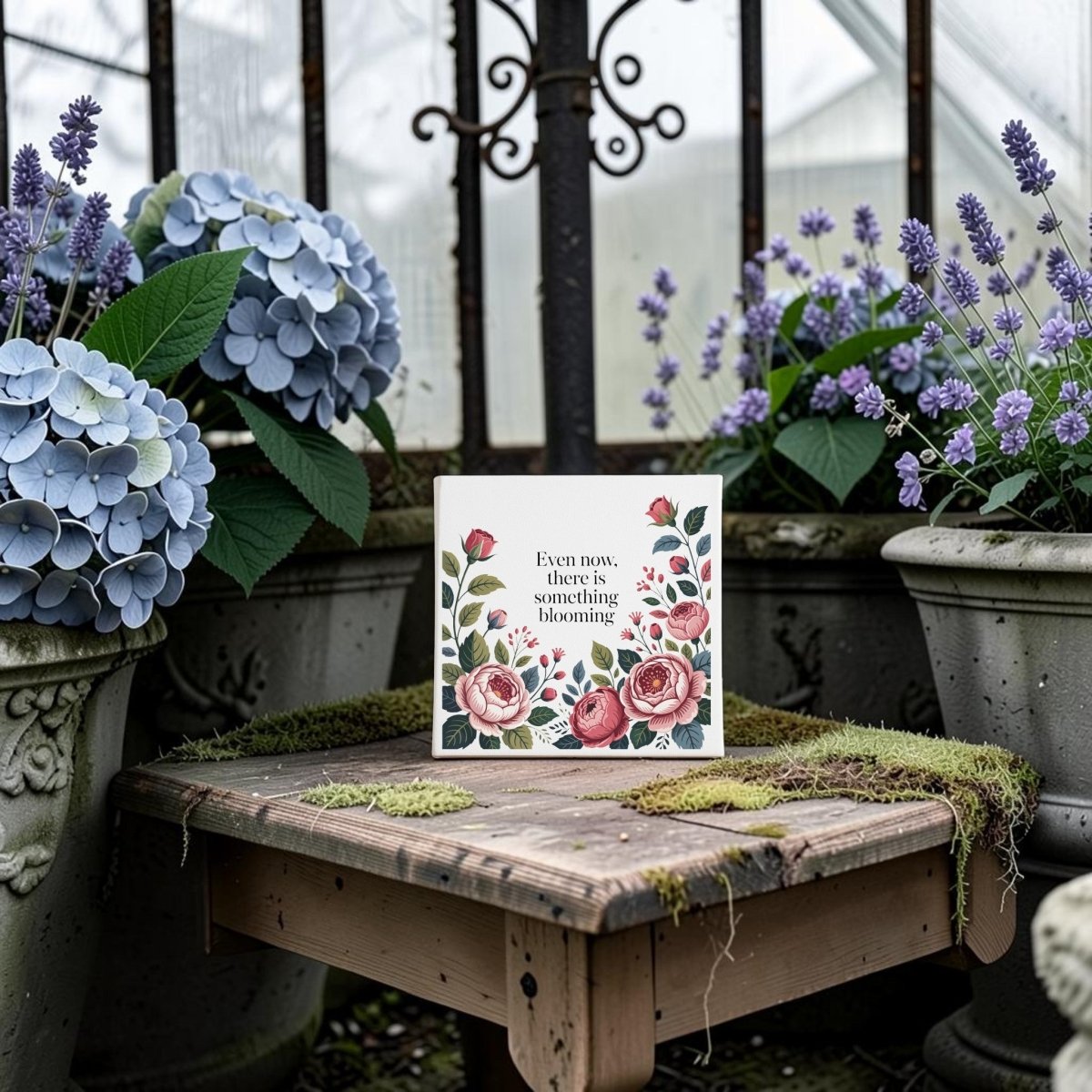 The Mirabilia Boutique “Even Now There Is Something Blooming” Canvas Wall Art features floral designs and inspiring text, perfect for encouragement. Display it in your home or greenhouse for a serene touch.