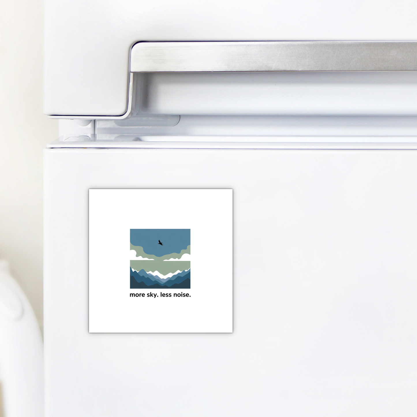 The Mirabilia Boutique More Sky Less Noise Nature Magnet features a minimalist mountain, cloud, and bird design with the words “more sky. less noise.”—a perfect outdoor gift or modern decor accent for your refrigerator.