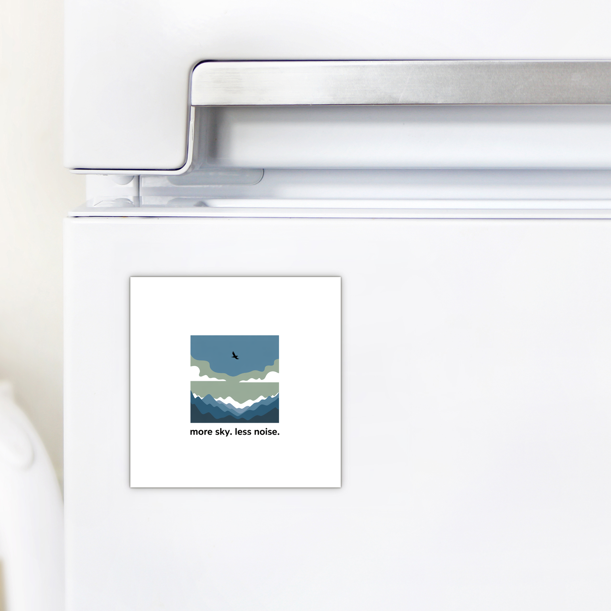 The Mirabilia Boutique More Sky Less Noise Nature Magnet features a minimalist mountain, cloud, and bird design with the words “more sky. less noise.”—a perfect outdoor gift or modern decor accent for your refrigerator.