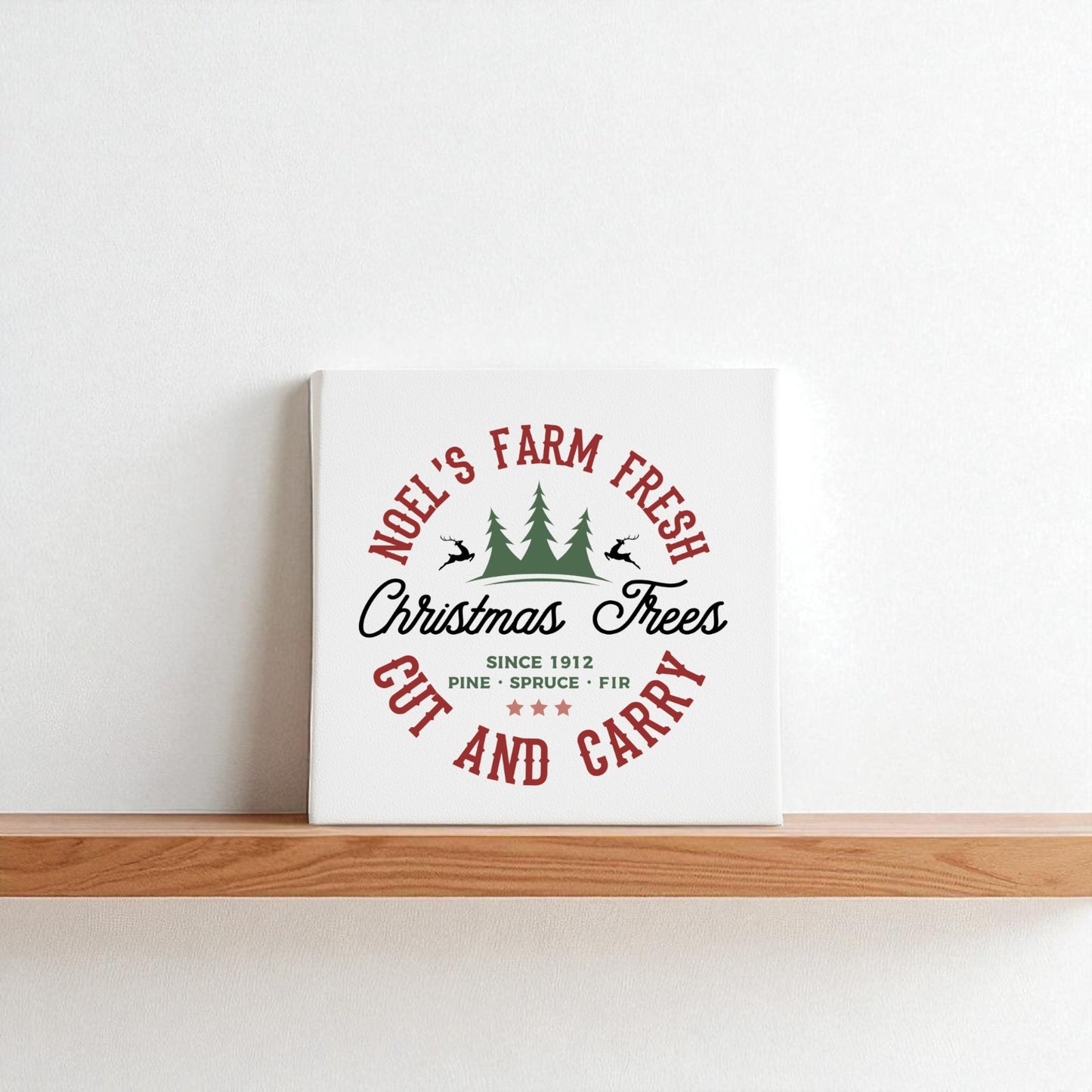The Farm Fresh Christmas Tree Sign by Mirabilia Boutique is a rustic 8x8 white canvas featuring “Noel’s Farm Fresh Christmas Trees, Since 1912, Pine • Spruce • Fir, Cut and Carry” in red/black with green trees—perfect for holiday decor.