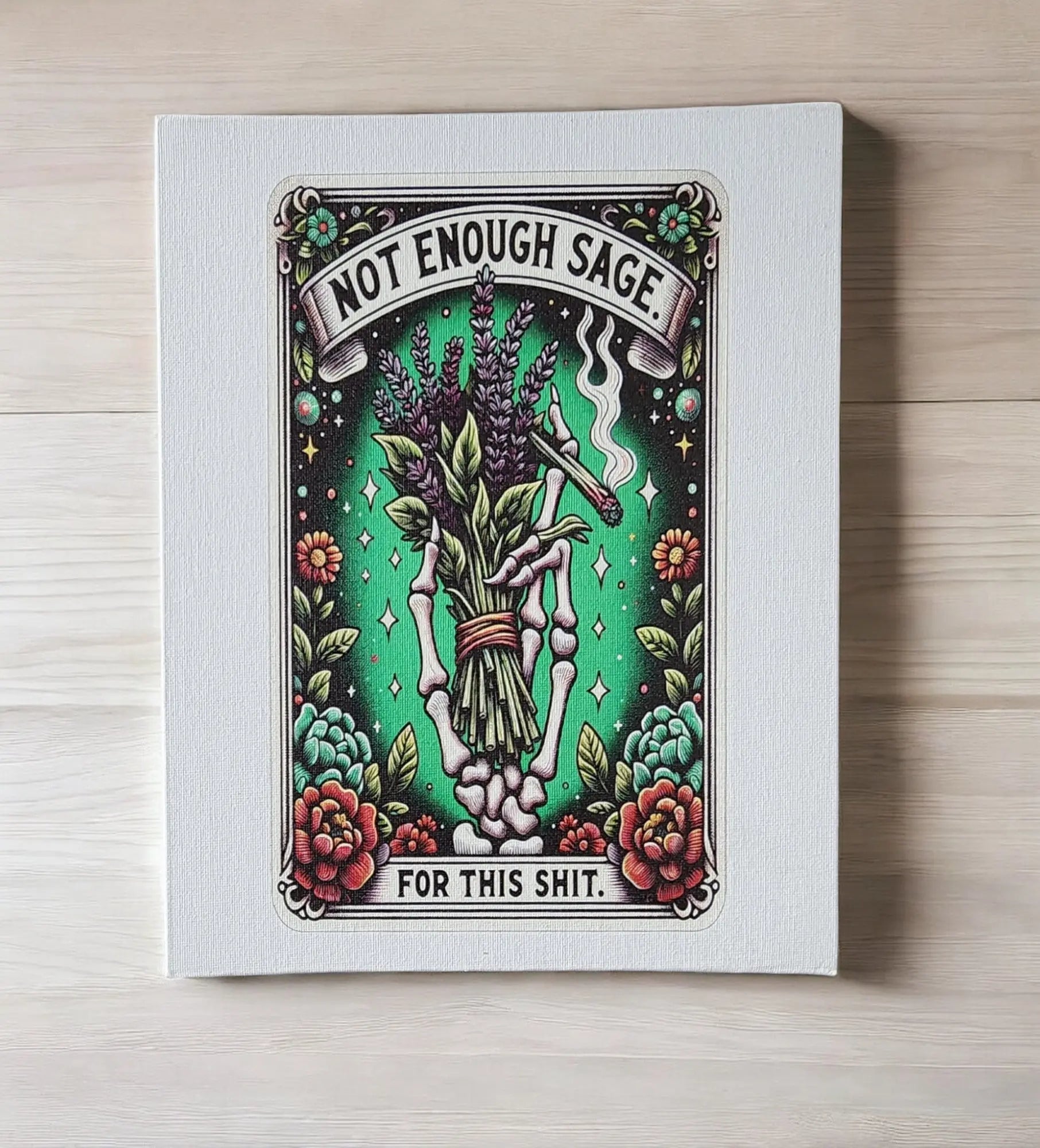 Mirabilia Boutique's "Humorous Sage Quote Wall Art Print for Home or Office Decor" features a skeleton hand grasping sage and lavender against a green background. The playful text, "Not Enough Sage for this Shit," is encircled by colorful flowers, making it the perfect witty and edgy art gift.