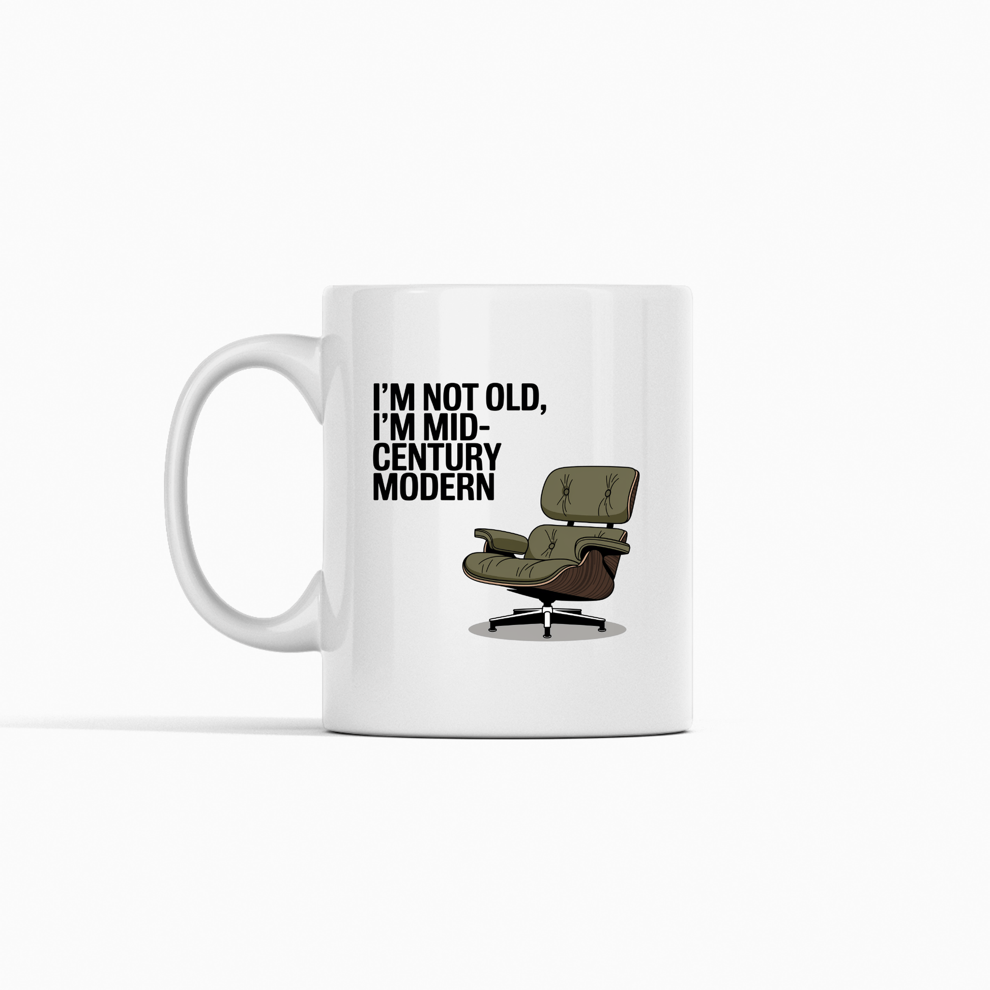 The Mirabilia Boutique Mid-Century Modern Mug with Retro Humor features a white ceramic design, green lounge chair illustration, and the phrase “I’m not old, I’m mid-century modern”—ideal for vintage style lovers.
