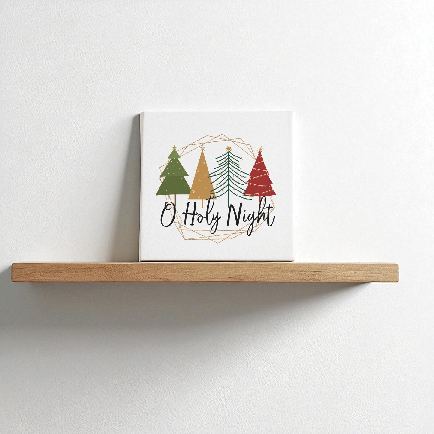 The O Holy Night Canvas Sign (8x8) by Mirabilia Boutique features three stylized Christmas trees and script text, adding minimalist, faith-inspired holiday decor to your wall.