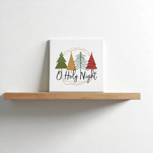 The O Holy Night Canvas Sign (8x8) by Mirabilia Boutique features three stylized Christmas trees and script text, adding minimalist, faith-inspired holiday decor to your wall.