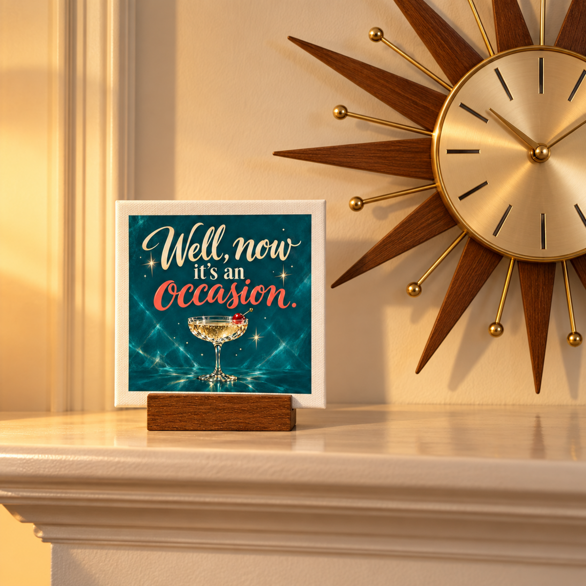 The Well, Now It’s an Occasion Mini Bar Sign | Chrome & Starlight sits on a wooden stand, featuring the phrase “Well, now it’s an occasion” above an illustration of a cocktail glass with a cherry on a mini canvas.