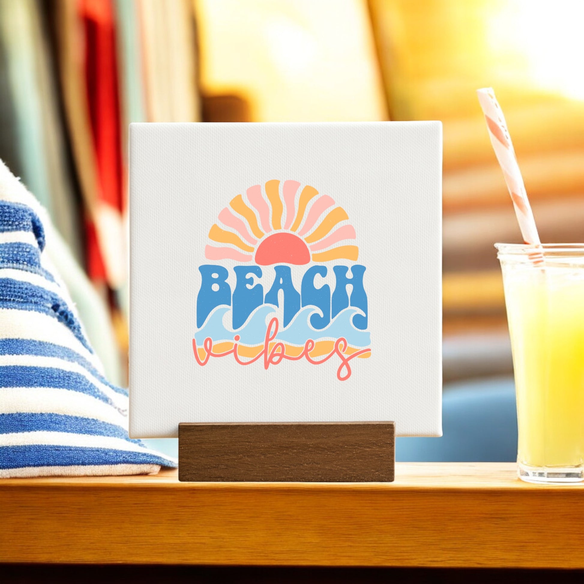 The Beach Vibes Mini Canvas – Retro Summer Desk Art from Mirabilia Boutique features a retro sun, waves, and "Beach vibes" text on a wooden stand—a perfect summer gift or beach-themed decor.