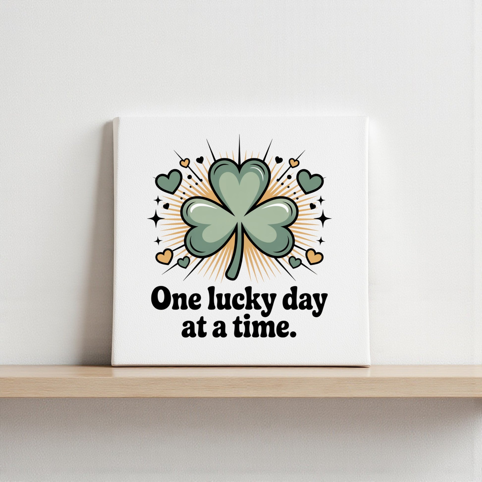 The One Lucky Day at a Time Canvas by Mirabilia Boutique features a green shamrock with hearts and sparkles, plus the phrase "One lucky day at a time." Ideal for optimistic home decor or charming shamrock wall art.