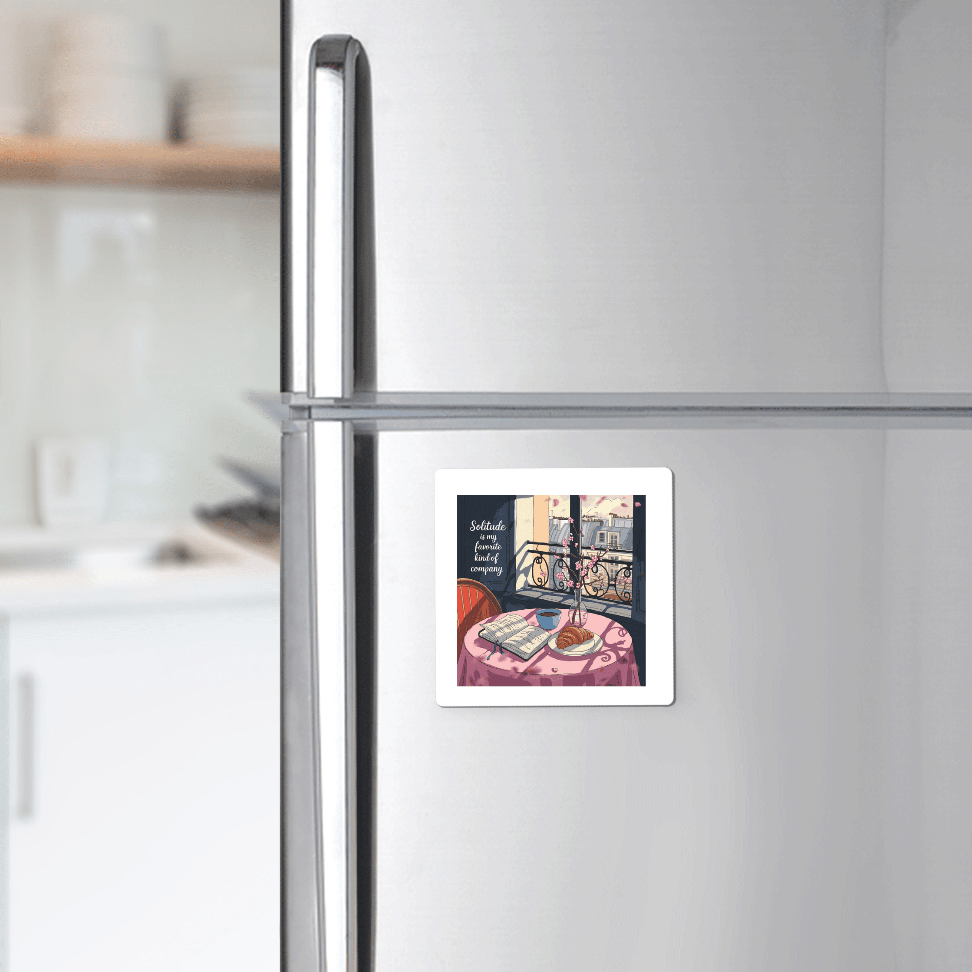 The Solitude Magnet – Paris Morning Still Life by Mirabilia Boutique features a handcrafted illustration of a cozy table with a teacup, book, and vase by a sunlit window, bringing Parisian apartment charm to your fridge.