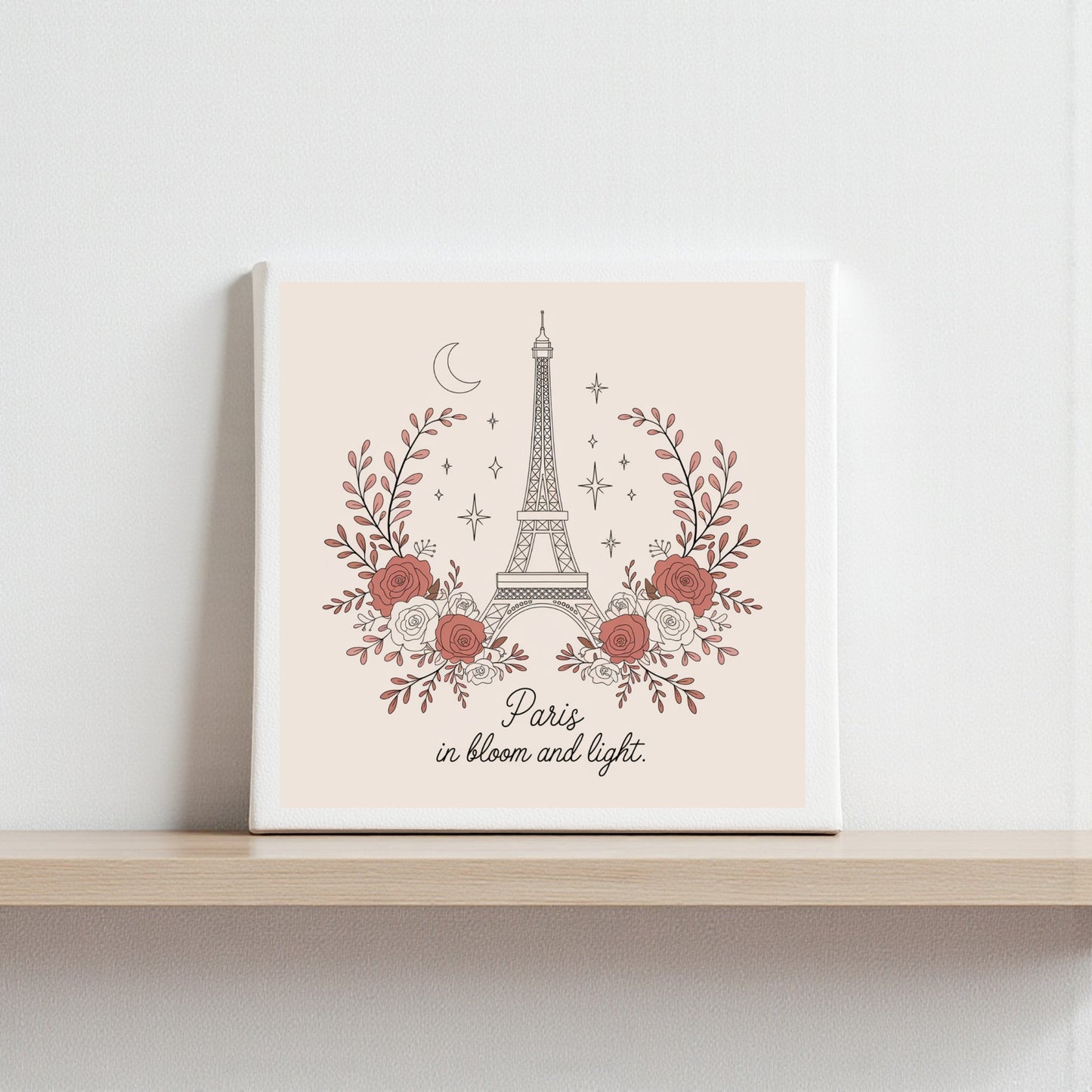 The Mirabilia Boutique Paris in Bloom and Light Canvas – Rosy Eiffel Tower Art features a dreamy Eiffel Tower with red and white flowers, stars, and a crescent moon—perfect romantic decor with "Paris in bloom and light" below.