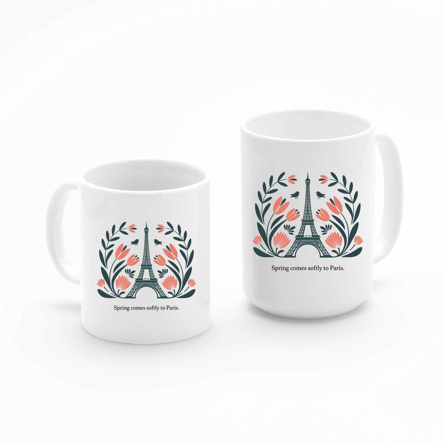 The Paris Spring Mug – Eiffel Tower & Floral Design by Mirabilia Boutique showcases the Eiffel Tower with pink flowers and green leaves, plus the phrase "Spring comes softly to Paris," all set against a white background.