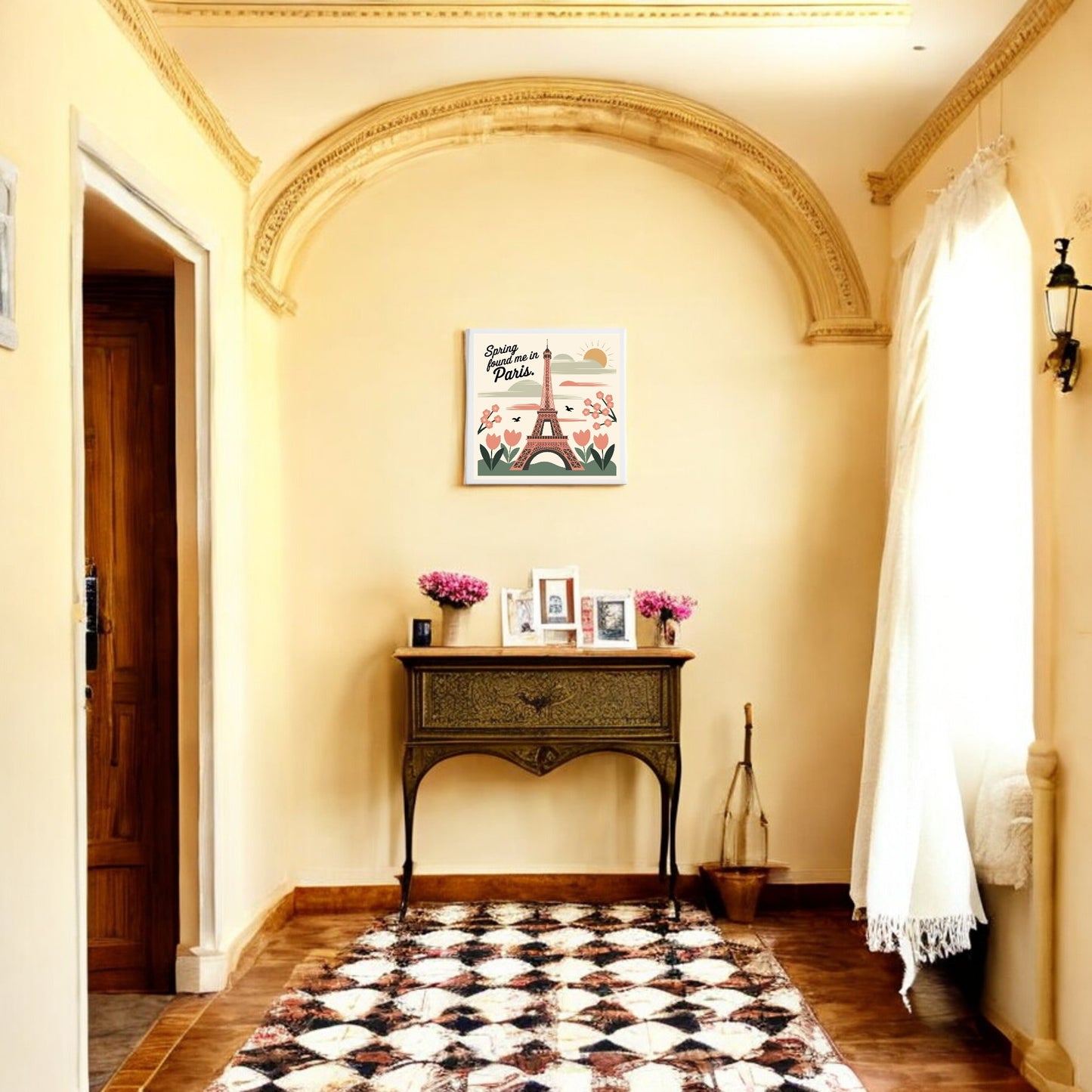 A hallway with cream walls, an arched ceiling, a vintage table with flowers and framed photos, patterned rug, and natural light is brought to life by Mirabilia Boutique’s "Spring Found Me in Paris – Eiffel Tower Art Canvas.