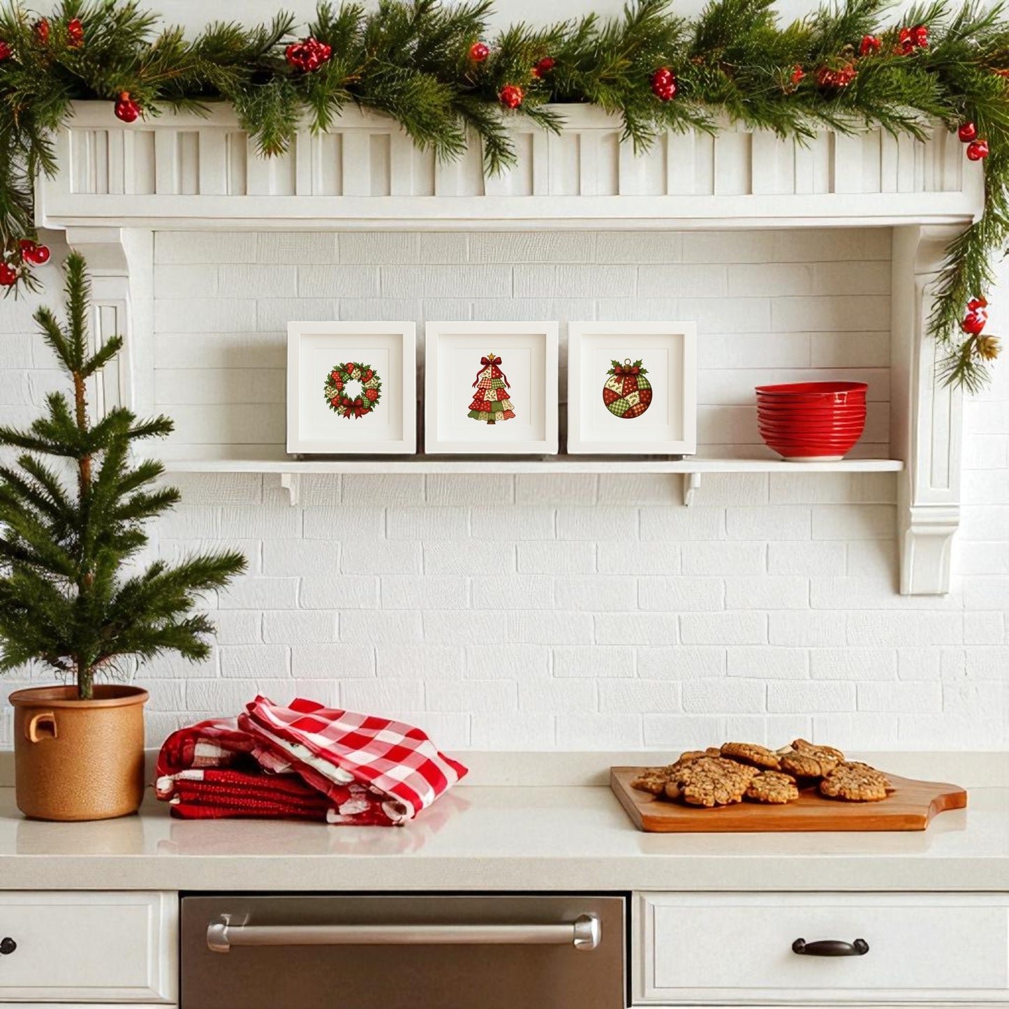 A festive kitchen features Mirabilia Boutique's Patchwork Christmas Wall Art Trio (5x5 Holiday Shadowbox Decor), red bowls, plaid towels, a potted pine, and cookies on a white countertop for holiday charm.