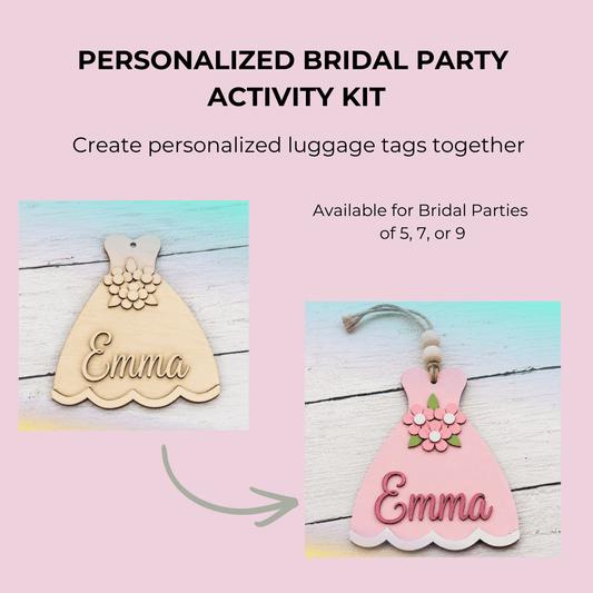 Image of the Mirabilia Boutique Personalized Bridal Party Activity Kit—guests craft custom dress-shaped luggage tags. Shown: wood and pink tags with floral accents and "Emma," displayed on a pastel background. Perfect for unique bridal shower fun.