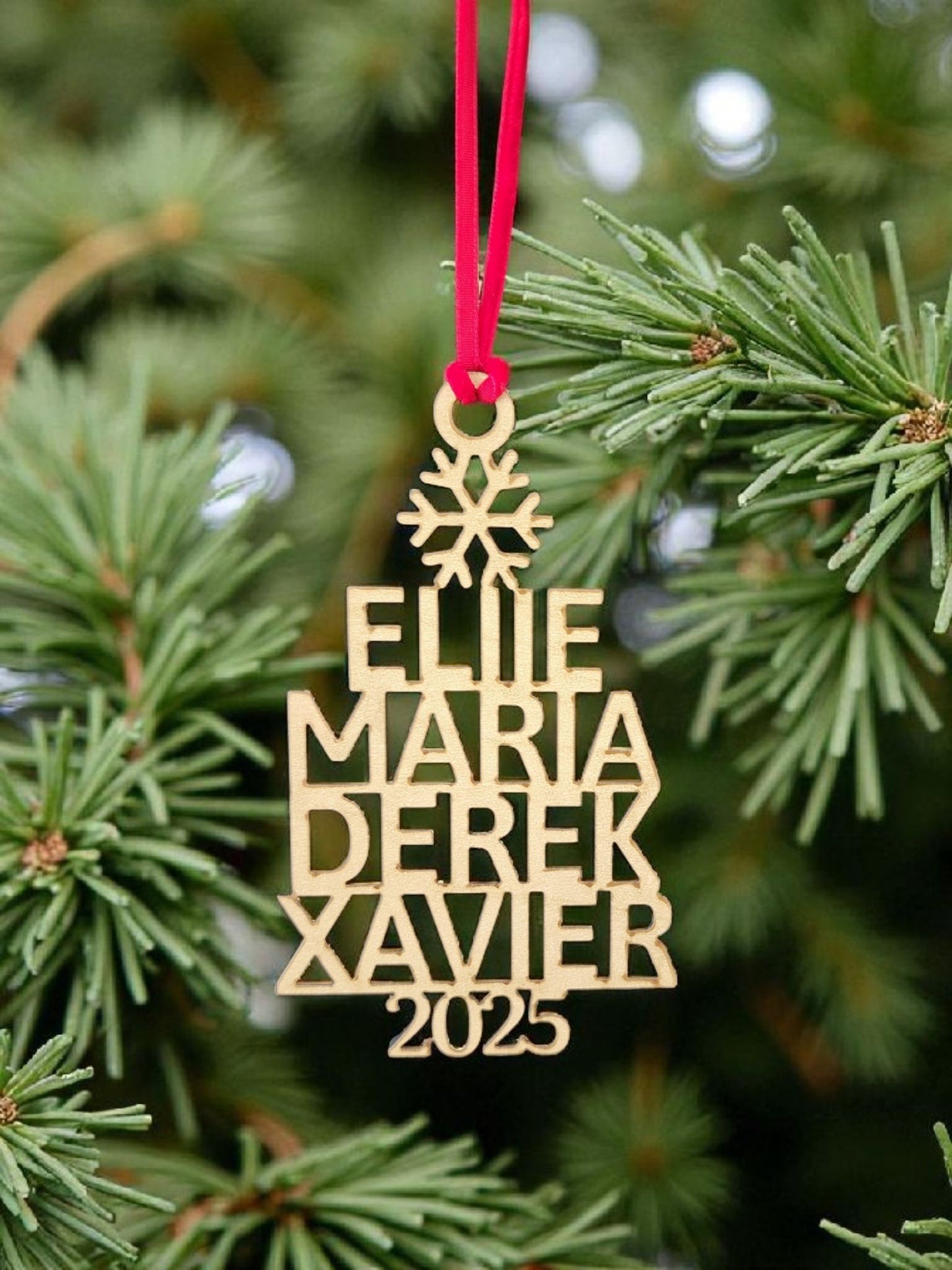 The Mirabilia Boutique Custom Family Christmas Ornament With Year features your chosen names, the year 2025, a snowflake top, and red ribbon—making it a perfect personalized holiday keepsake for your tree.