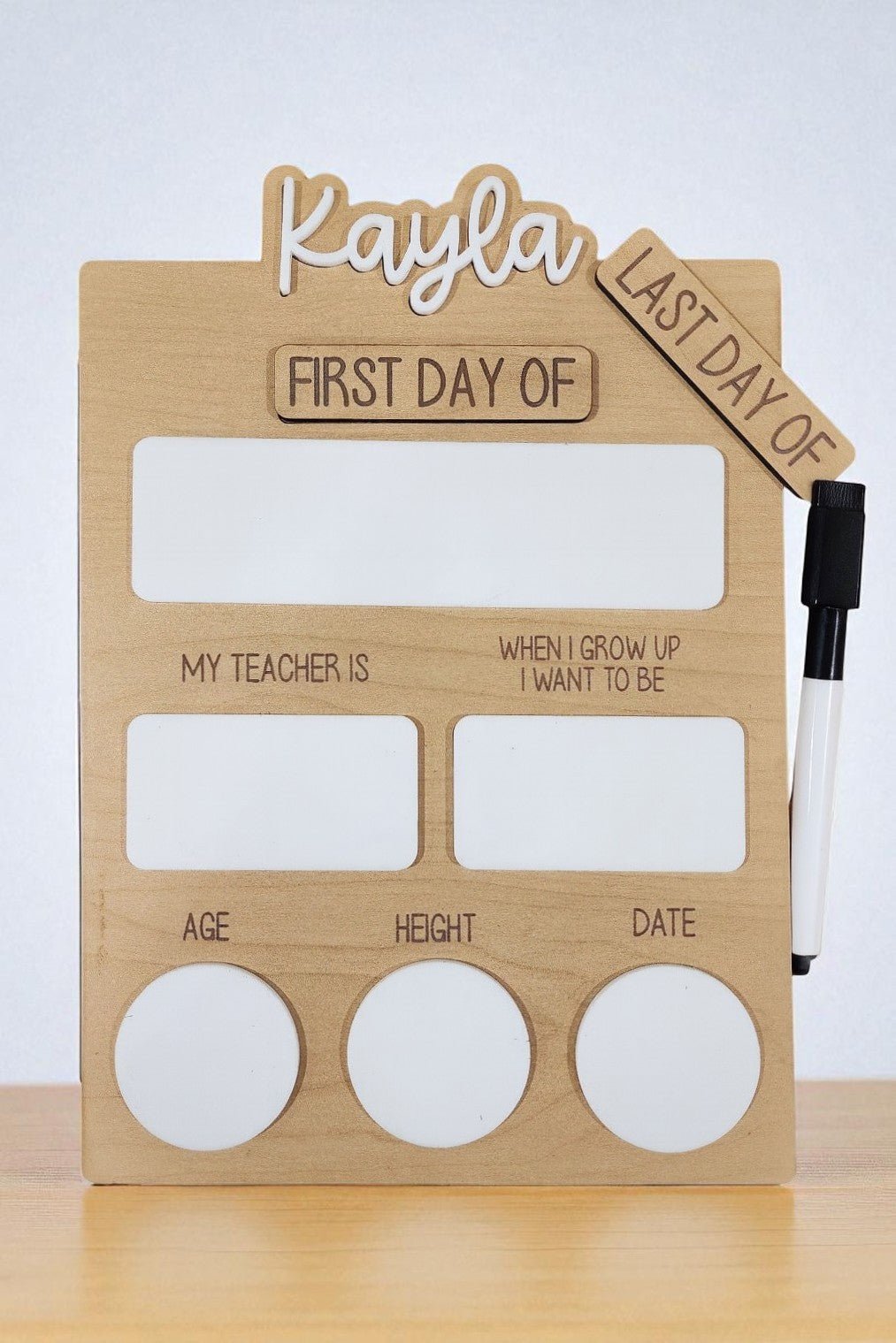 The Mirabilia Boutique Reusable School Board | First & Last Day of School Sign features sections for "First/Last Day of," "My Teacher Is," "Age," and more, with marker included—ideal for capturing your child's school milestones.