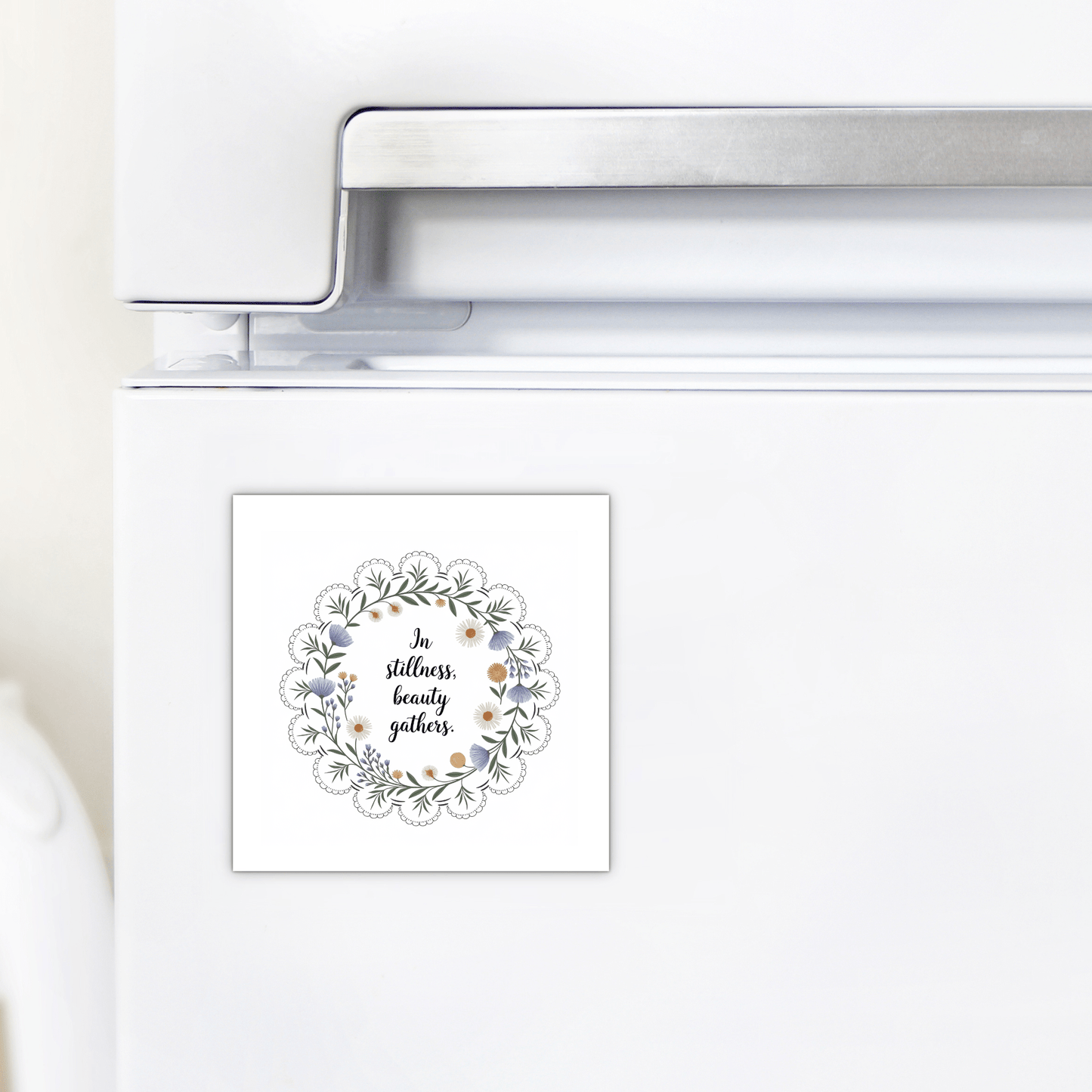 The In Stillness Beauty Gathers Floral Quote Magnet by Mirabilia Boutique features a wreath and the phrase “In stillness, beauty gathers”—an inspirational accent ideal for mindful home decor.