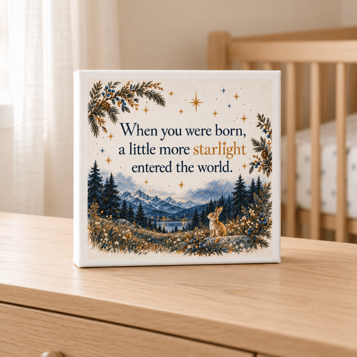 A Little More Starlight Canvas square print featuring a small rabbit in a forest and mountain landscape with the text, “When you were born, a little more starlight entered the world,” designed for a nursery.