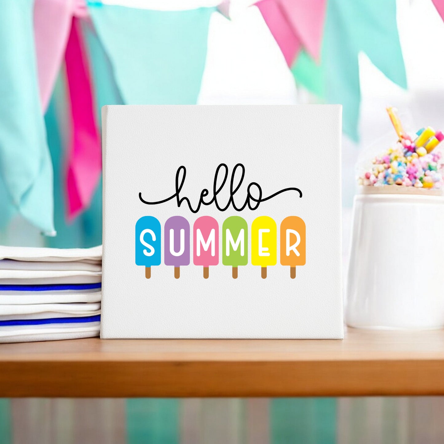 The Mirabilia Boutique Hello Summer Popsicle Canvas Sign is an 8x8 colorful wall art featuring "hello summer" with "summer" displayed on popsicle illustrations, perfect for brightening up your decor.