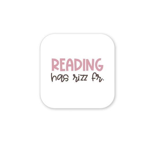 The Reading Has Rizz Fr Magnet by Mirabilia Boutique is a square white magnet sticker with “READING has rizz fr.” in pink and brown text—ideal for classroom decor or a fun teacher gift.