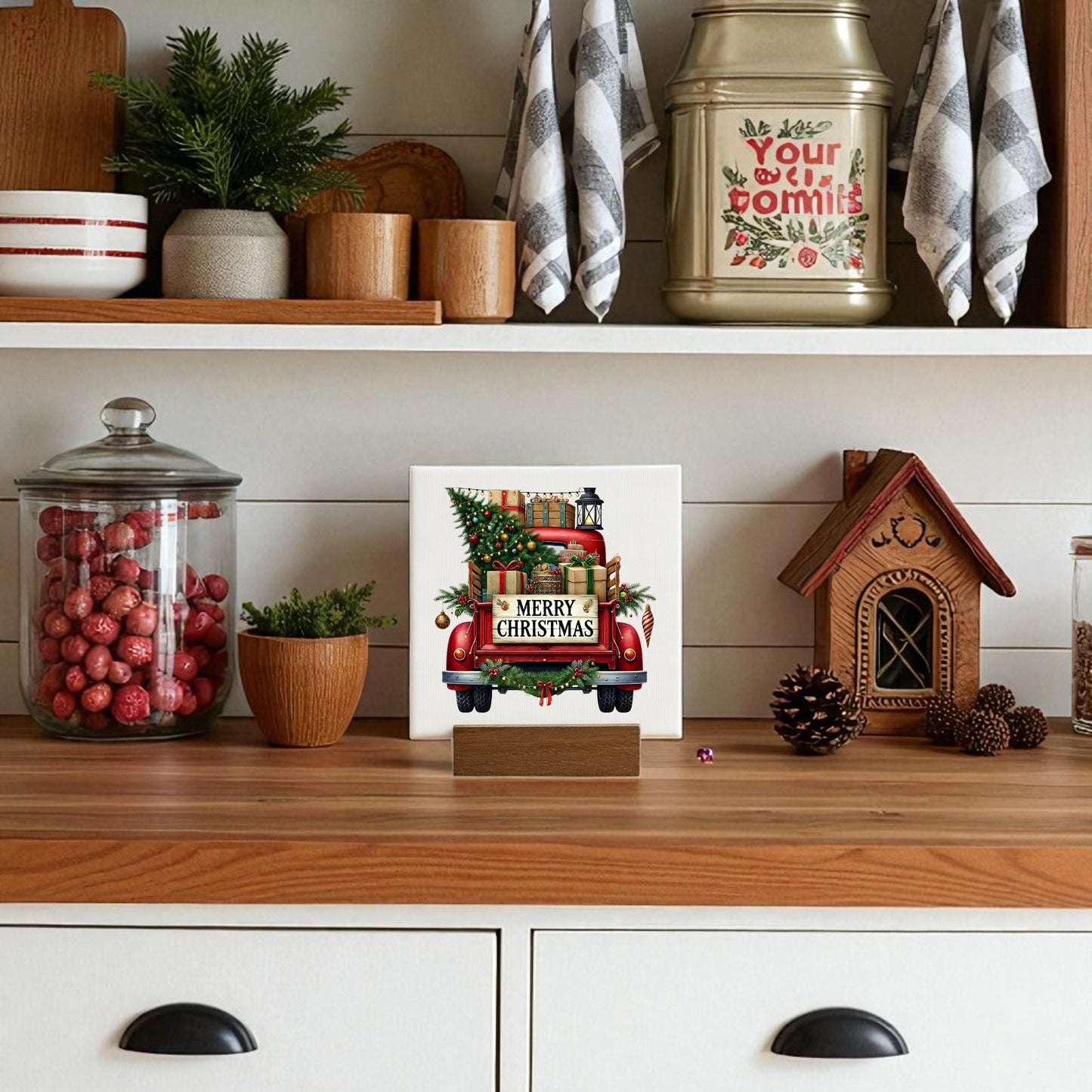 A festive kitchen shelf featuring Mirabilia Boutique's Red Merry Christmas Truck Mini Sign—rustic holiday decor with a red truck carrying a tree and gifts, plus "Merry Christmas" on the back, ideal for your seasonal display.