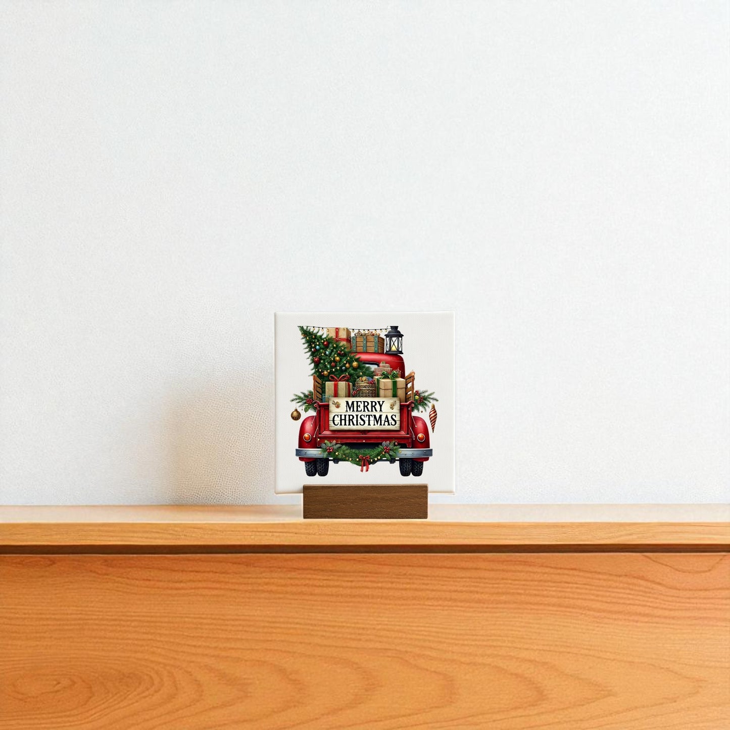 The Red Merry Christmas Truck Mini Sign by Mirabilia Boutique features a rustic red truck with a tree and gifts, adding festive charm to your shelf or white wall this holiday season.