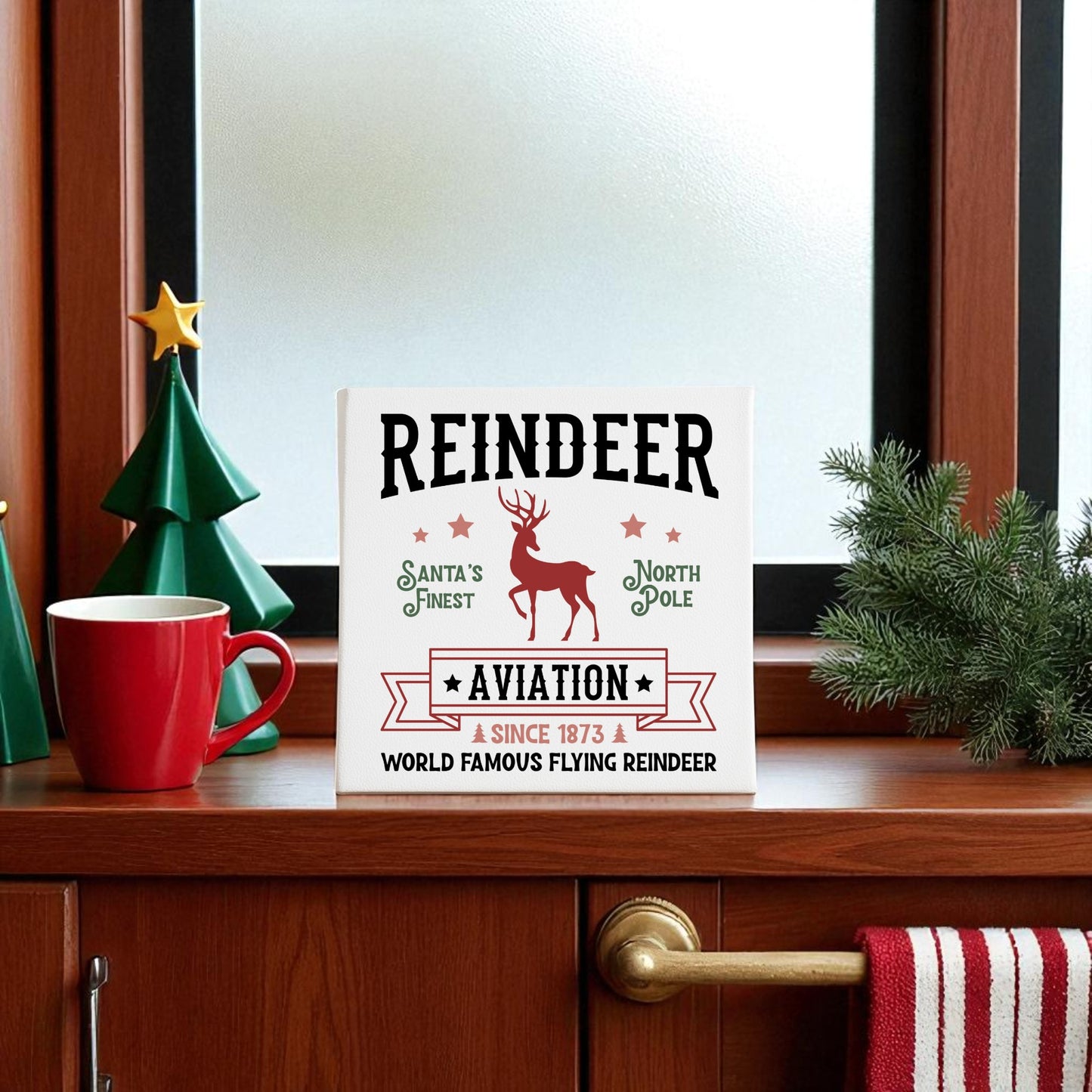 The Reindeer Aviation Christmas Sign | North Pole Canvas Decor by Mirabilia Boutique features the phrase "Reindeer Aviation - Santa's Finest, North Pole, Since 1873," adding vintage Christmas charm to any holiday display.