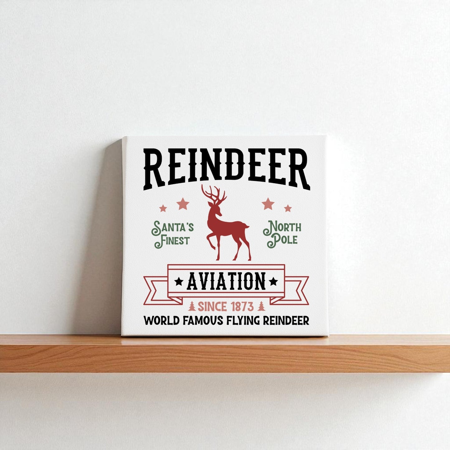 The Reindeer Aviation Christmas Sign by Mirabilia Boutique features a vintage North Pole design with reindeer art and festive text on canvas—perfect holiday decor for your home.