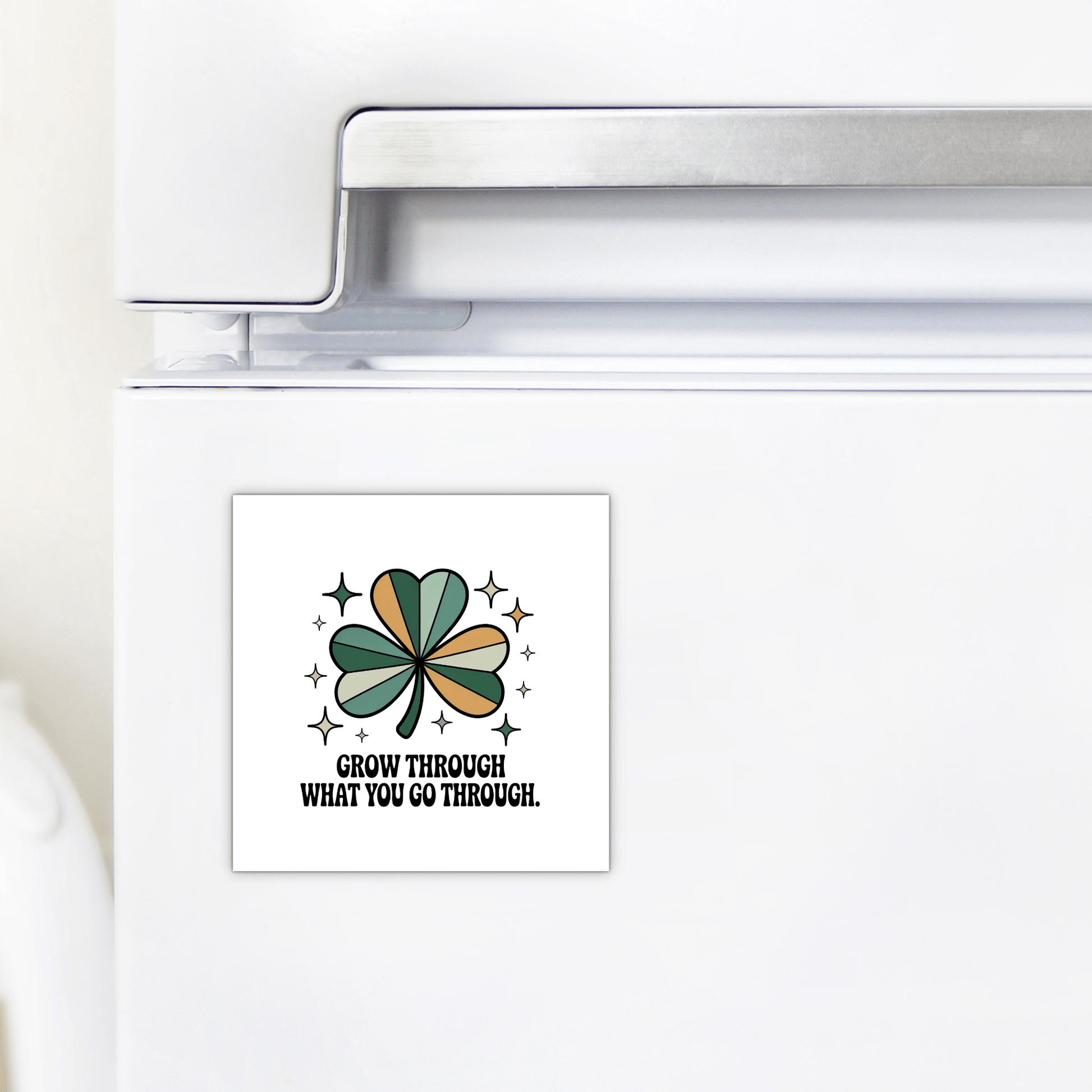 The Mirabilia Boutique "Grow Through What You Go Through" Magnet is a square fridge magnet with a green shamrock, stars, and an inspiring message—ideal for daily motivation and resilience.