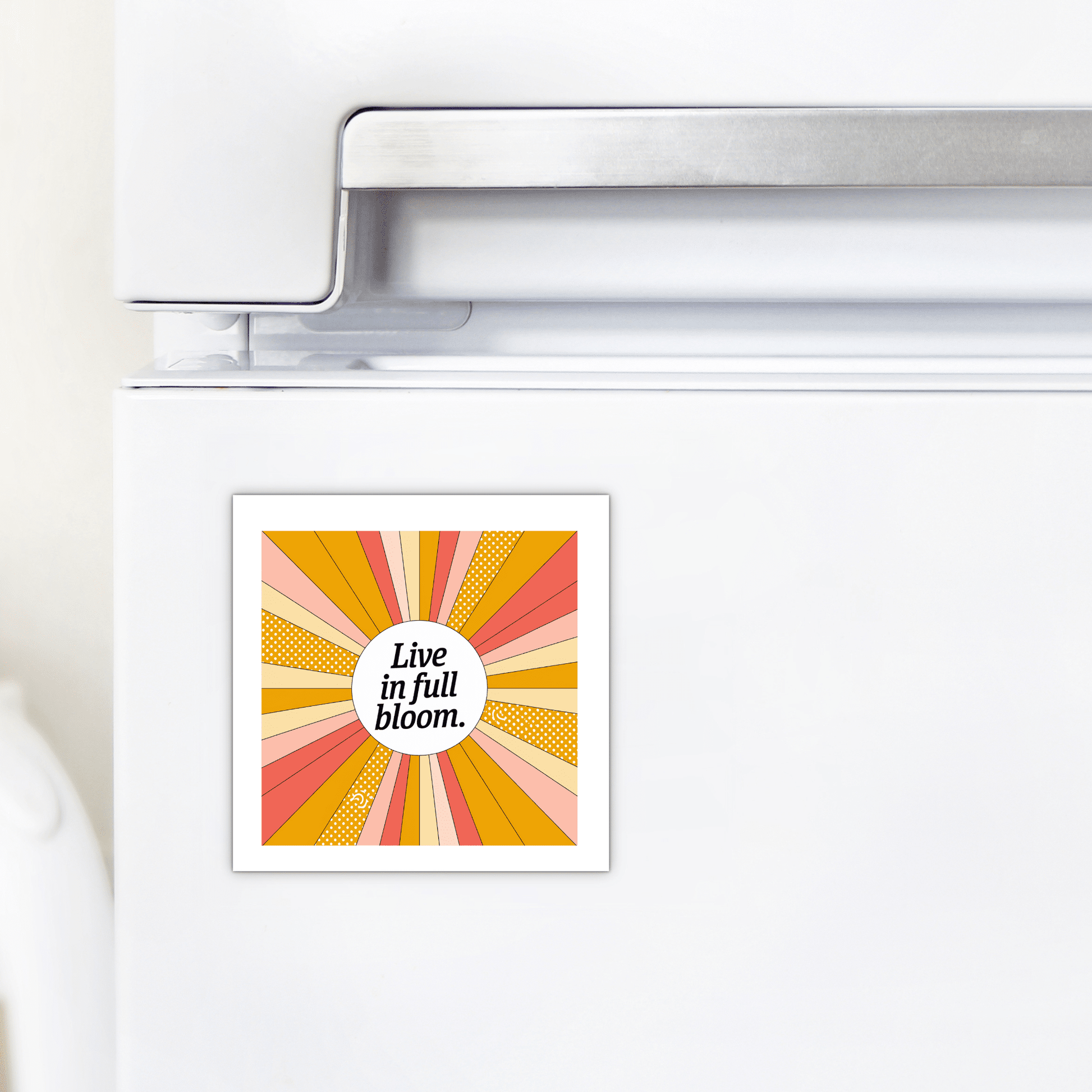 The Live in Full Bloom Magnet – Summer Sunburst Mini Art by Mirabilia Boutique features vibrant retro sunburst rays in yellow, orange, and pink with the phrase "Live in full bloom," making it an uplifting gift for any fridge.