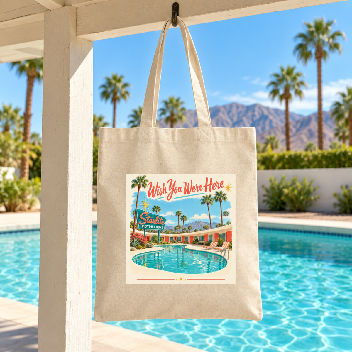 Wish You Were Here Tote | Chrome & Starlight featuring a mid-century postcard illustration of a motel pool with the text “Wish You Were Here” and “Starlite Motor Court.”.