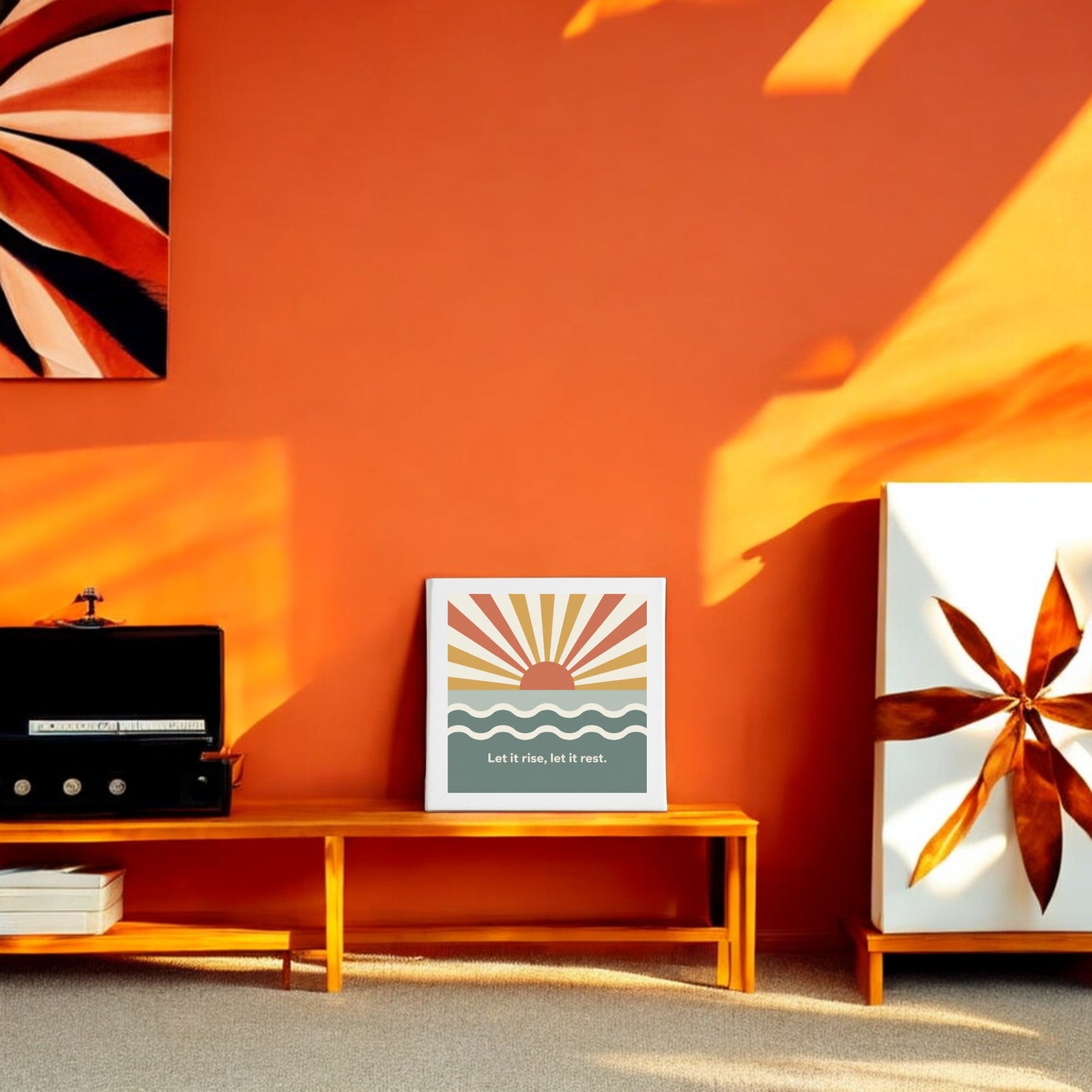 A bright orange living room with mid-century decor features the Mirabilia Boutique "Let It Rise, Let It Rest Canvas – Sunrise Mindful Art," a sun-over-waves print with inspiring text on a low bench, enhancing the space’s calm, meditative vibe.
