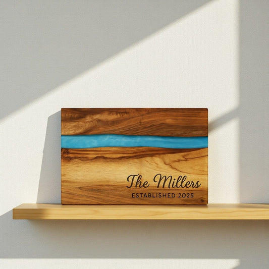 The Mirabilia Boutique Engraved Resin Acacia Board – Housewarming or Wedding features a blue stripe and custom engraving, making it the perfect personalized gift for weddings or housewarmings.