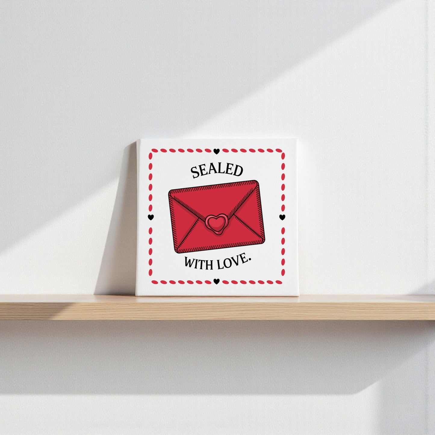 The Sealed With Love Valentine Canvas Art by Mirabilia Boutique features a red envelope and hearts on a square canvas, with "Sealed with Love." in black text—perfect Valentine’s Day decor that adds charm to any shelf.